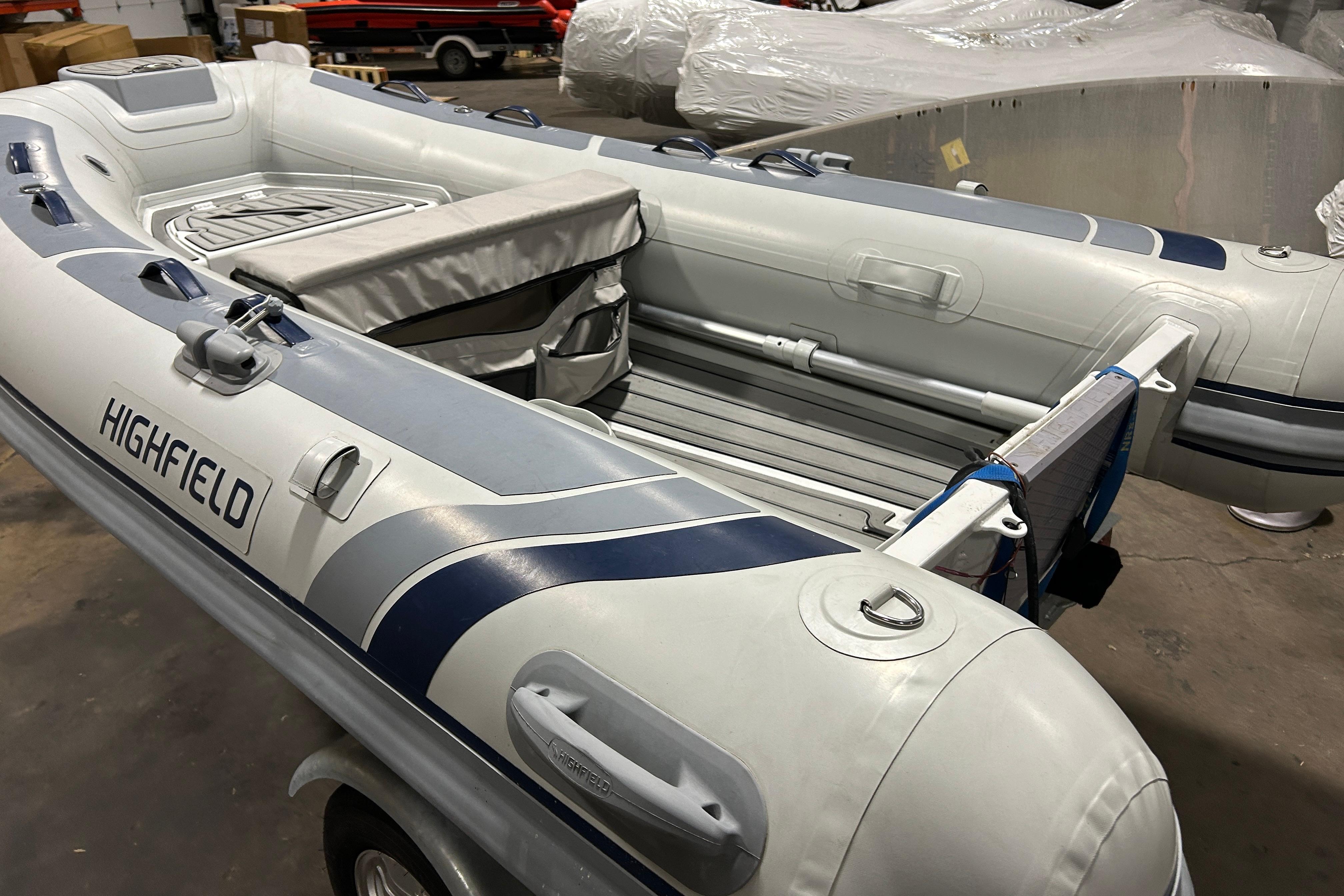 2023 Highfield Classic 310 inflatable boat in a warehouse setting.