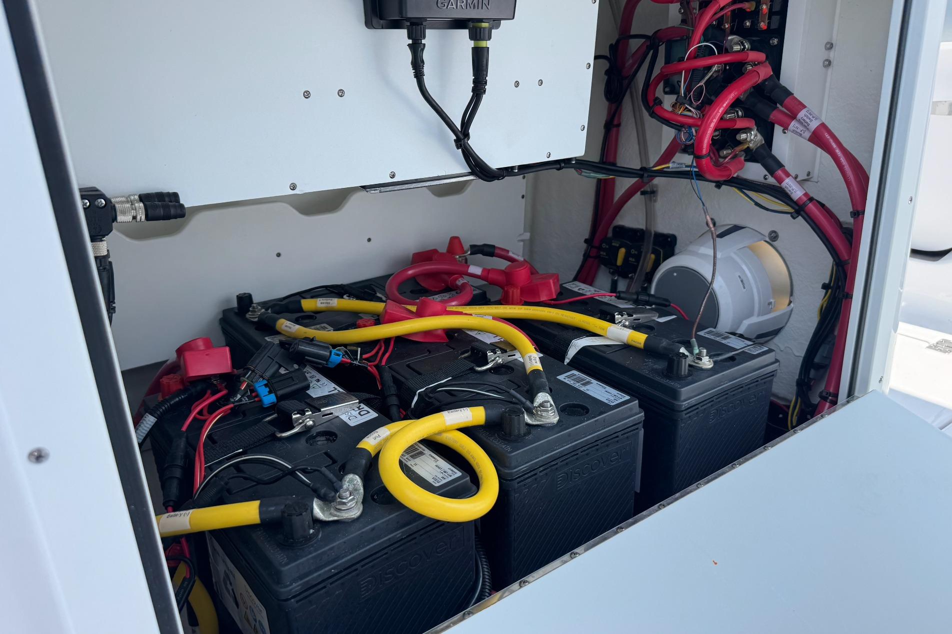 Battery compartment of 2026 Sportsman Open 262 Center Console boat, featuring wiring and connections.
