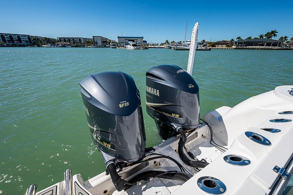 2018 Sea Fox 328 Commander with twin Yamaha V8 engines on a sunny day.