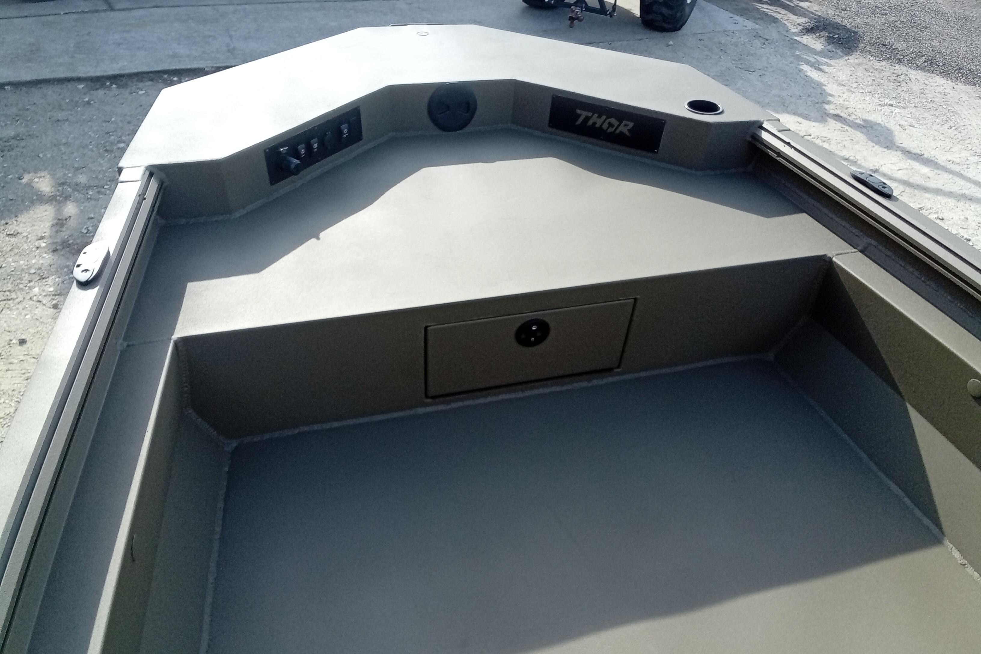 2026 Thor 1900 Low Country Elite boat interior with control panel and storage compartment.