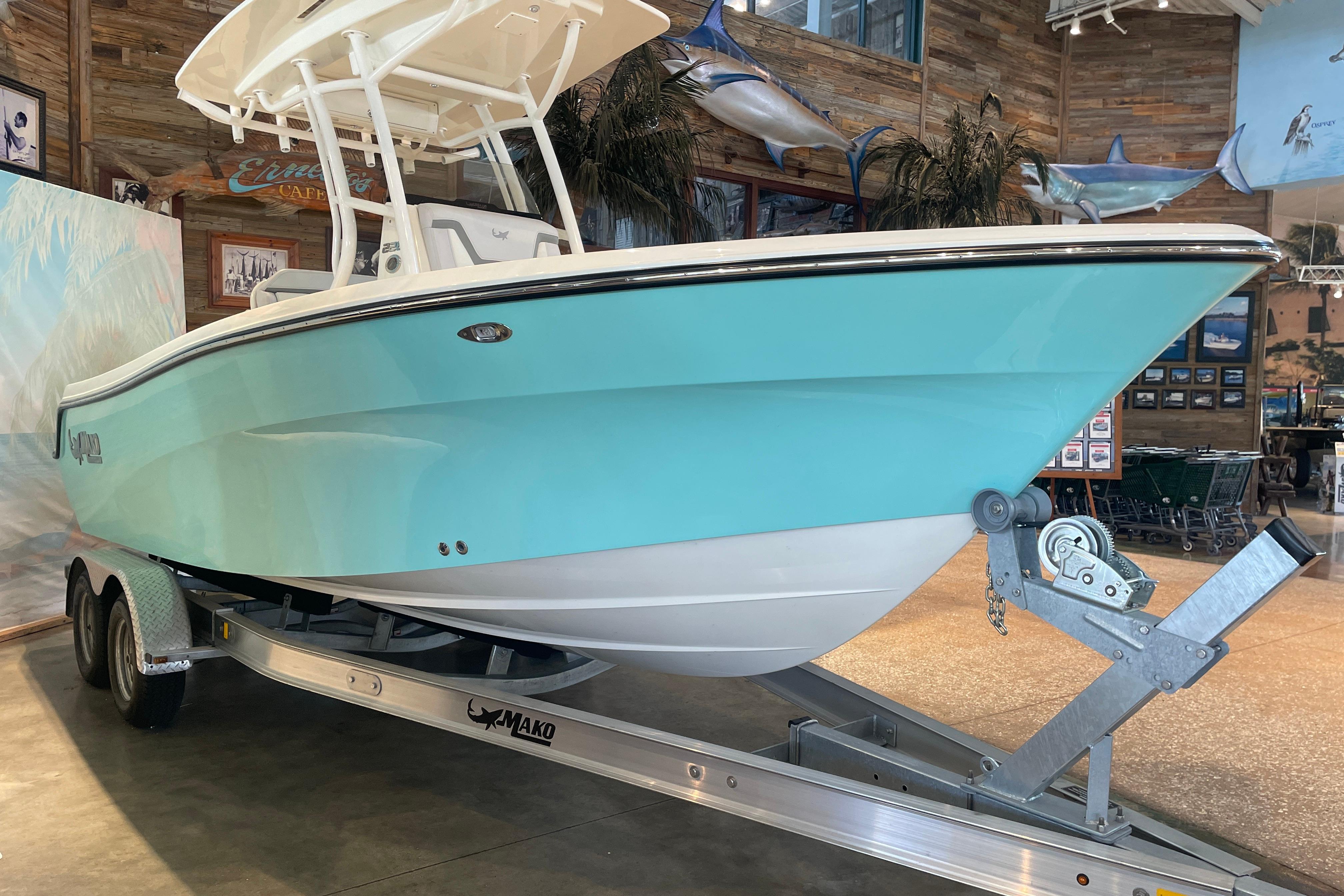 2026 Mako 226 Center Console boat on trailer in showroom setting.