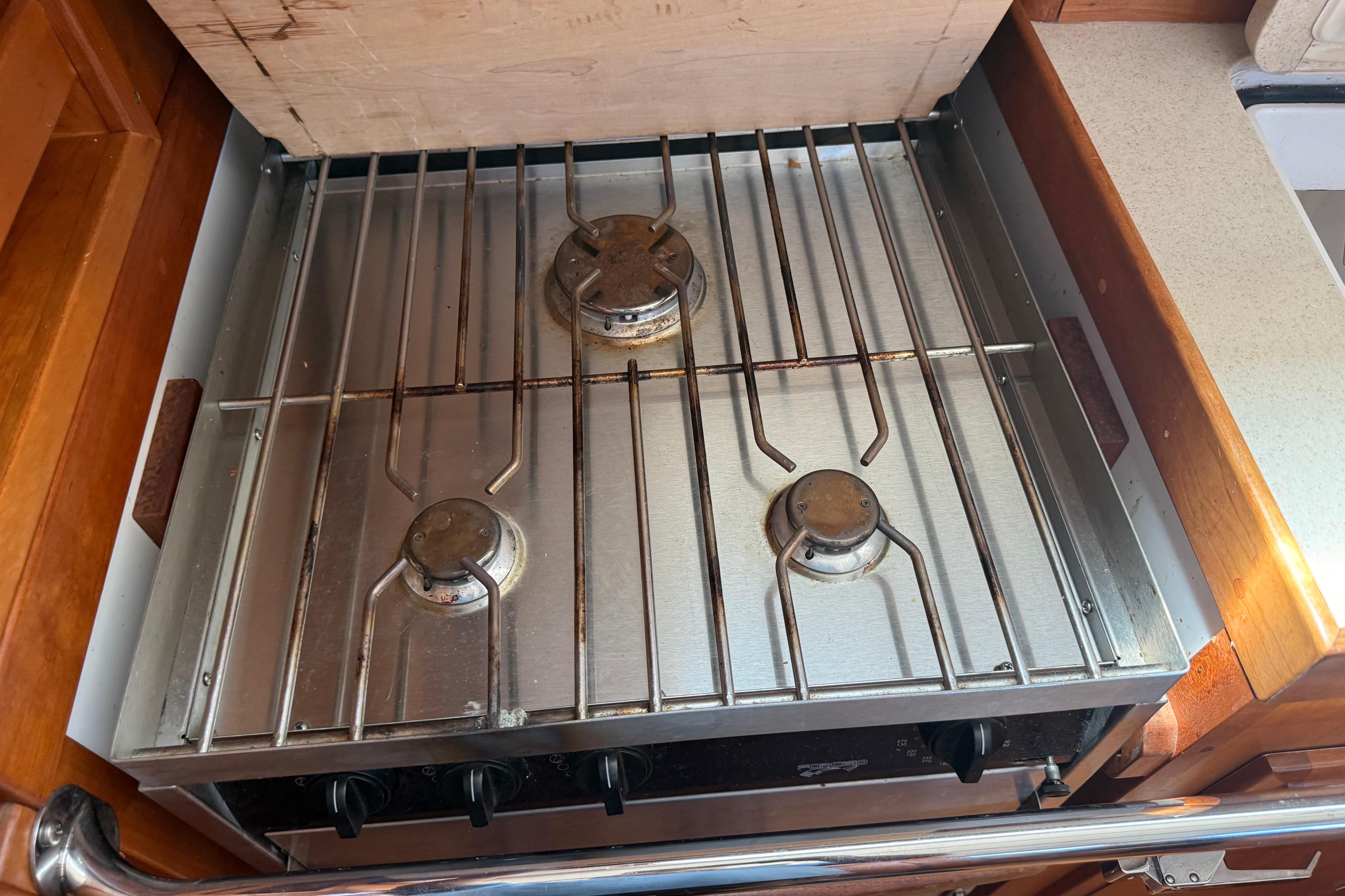 Three-burner stainless steel stove in a 2004 Sabre 386 yacht kitchen.