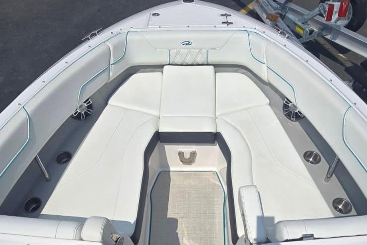 2020 Regal LS6 boat interior with white cushioned seating and cup holders.