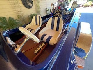 Interior view of a 1980 Sanger HYDRO V DRIVE with two striped seats.