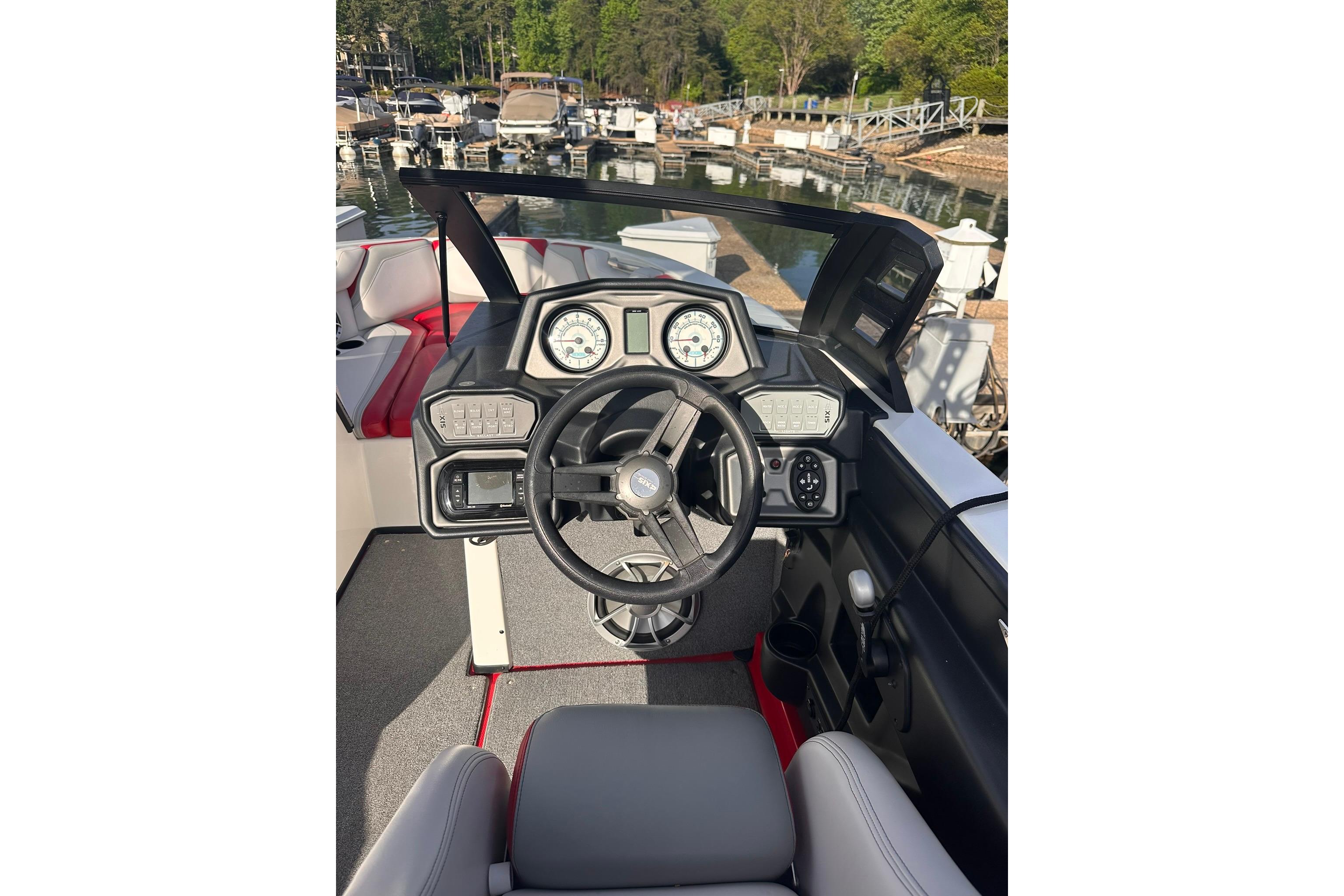 2017 Axis T23 boat dashboard with steering wheel and gauges at marina.