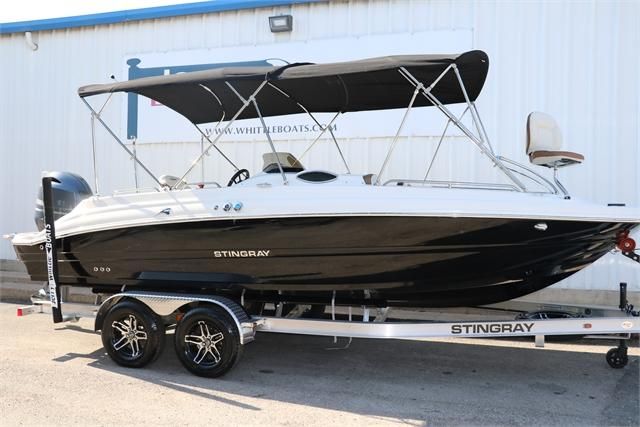 A 2022 Stingray 212 SC boat on a trailer, featuring a black hull and sunshade.