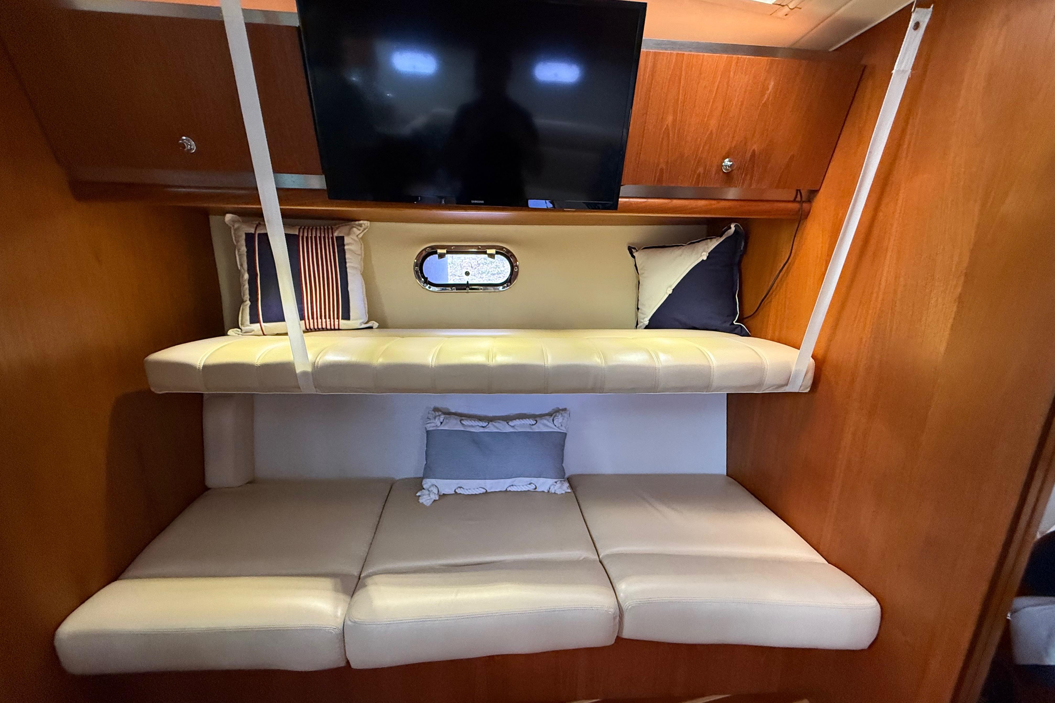 Interior of 2004 Tiara Yachts 3600 Sovran with cozy seating and TV.