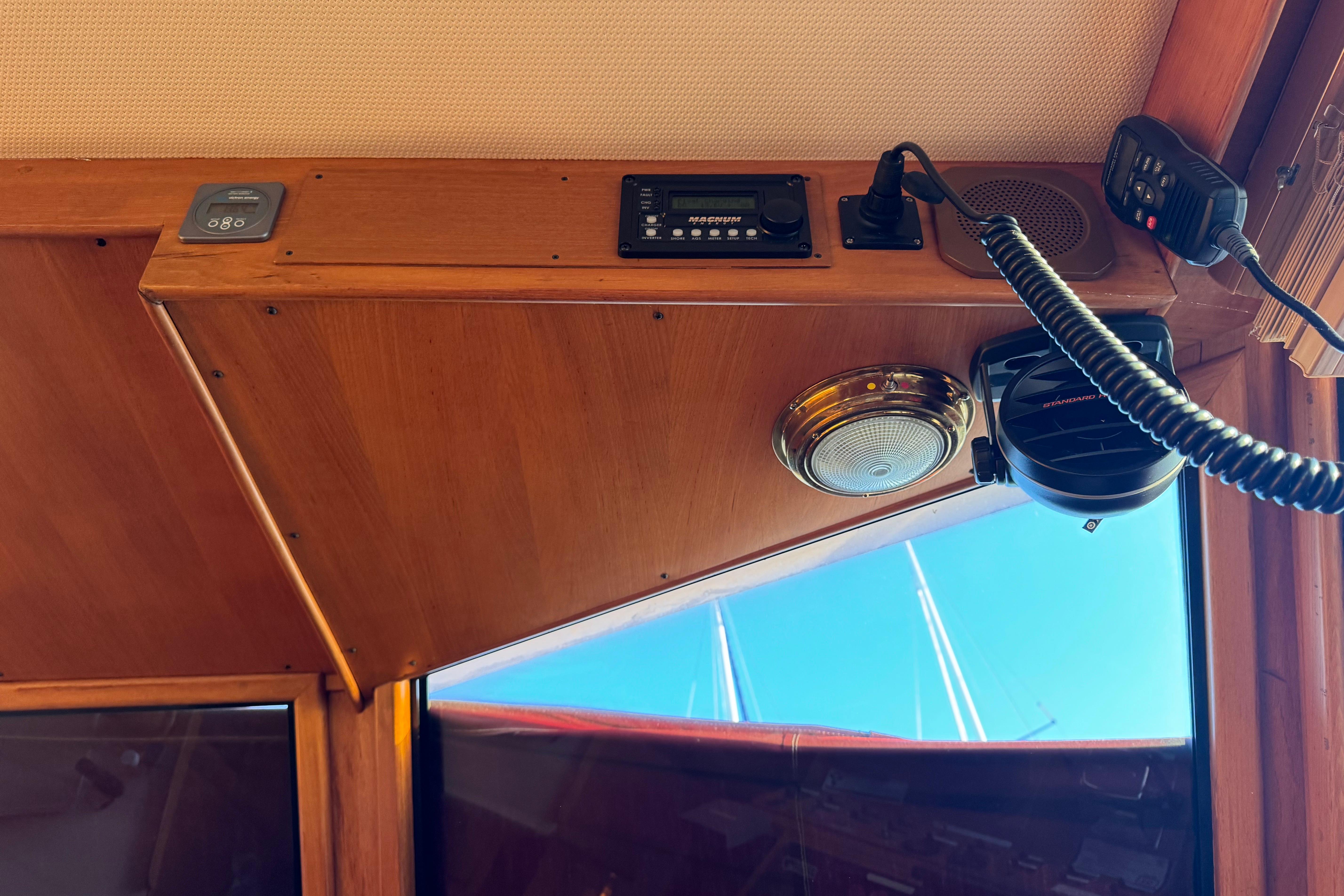 Interior view of a 1987 President 37 boat, featuring wooden paneling and communication equipment.