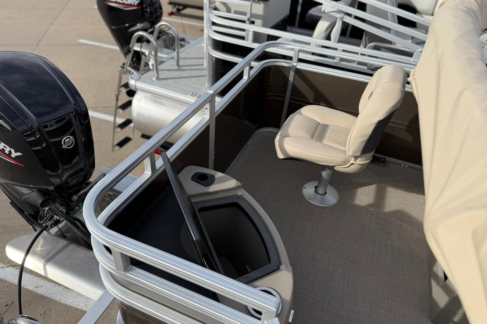 2025 Sun Tracker SportFish 20 DLX boat interior with seating and Mercury outboard motor.
