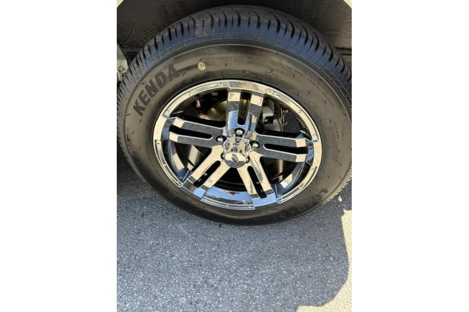 Chrome wheel of 2026 Ranger Z520R Cup-Equipped with Kenda tire on asphalt.
