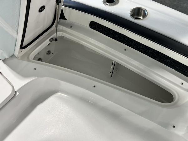 2025 Tidewater 2300 Carolina Bay boat storage compartment with cup holder and sleek design.