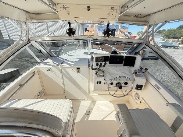 2001 Albemarle 280 Express Sport Fisherman cockpit with steering wheel and navigation equipment.