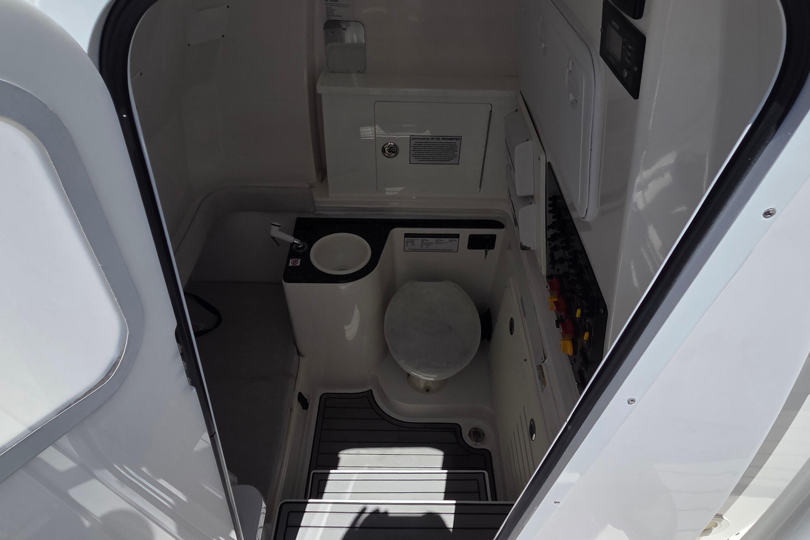 Interior view of 2021 Sea Fox 328 Commander boat's compact bathroom area.