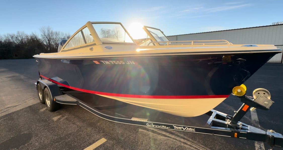 A 2018 Rossiter Coastal Cruiser on a trailer, featuring a blue hull with a red stripe.