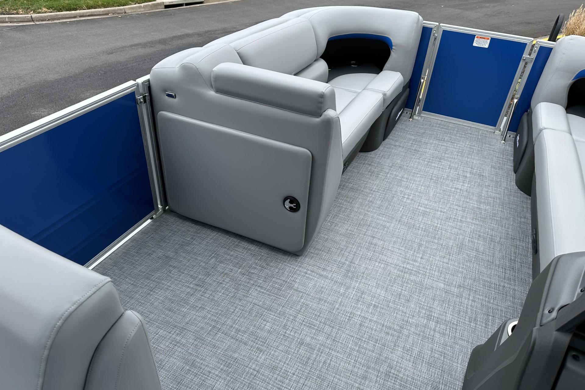 2026 Sun Tracker Party Barge 20 DLX interior with gray seating and blue accents.