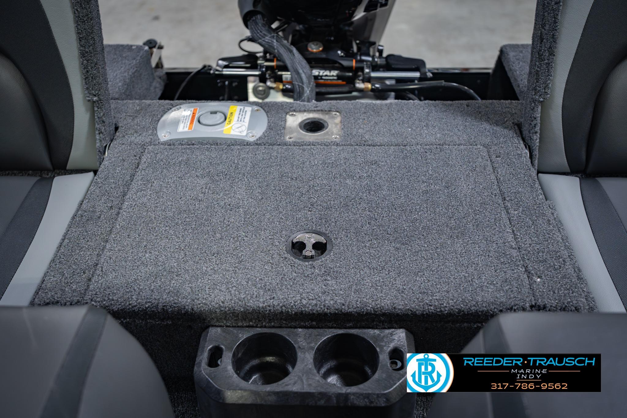 2026 Lund 1775 Impact XS boat interior with carpeted flooring and cup holders.