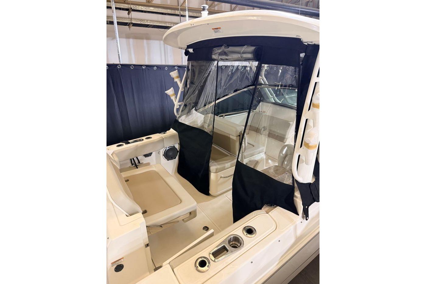 2025 Boston Whaler 240 Vantage boat interior with seating and protective cover.
