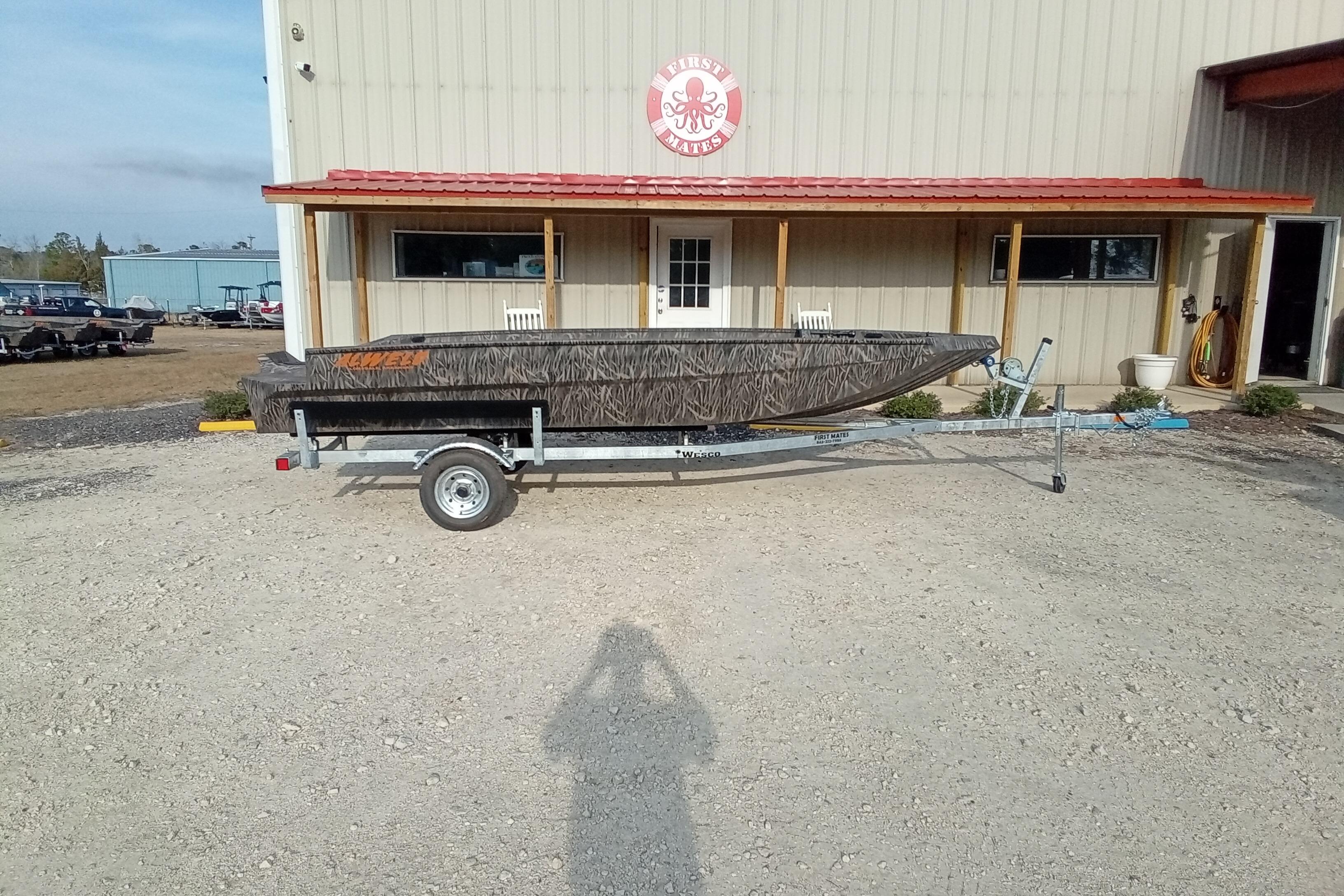 2026 Alweld 1756 Invader boat on trailer outside a building with red roof.