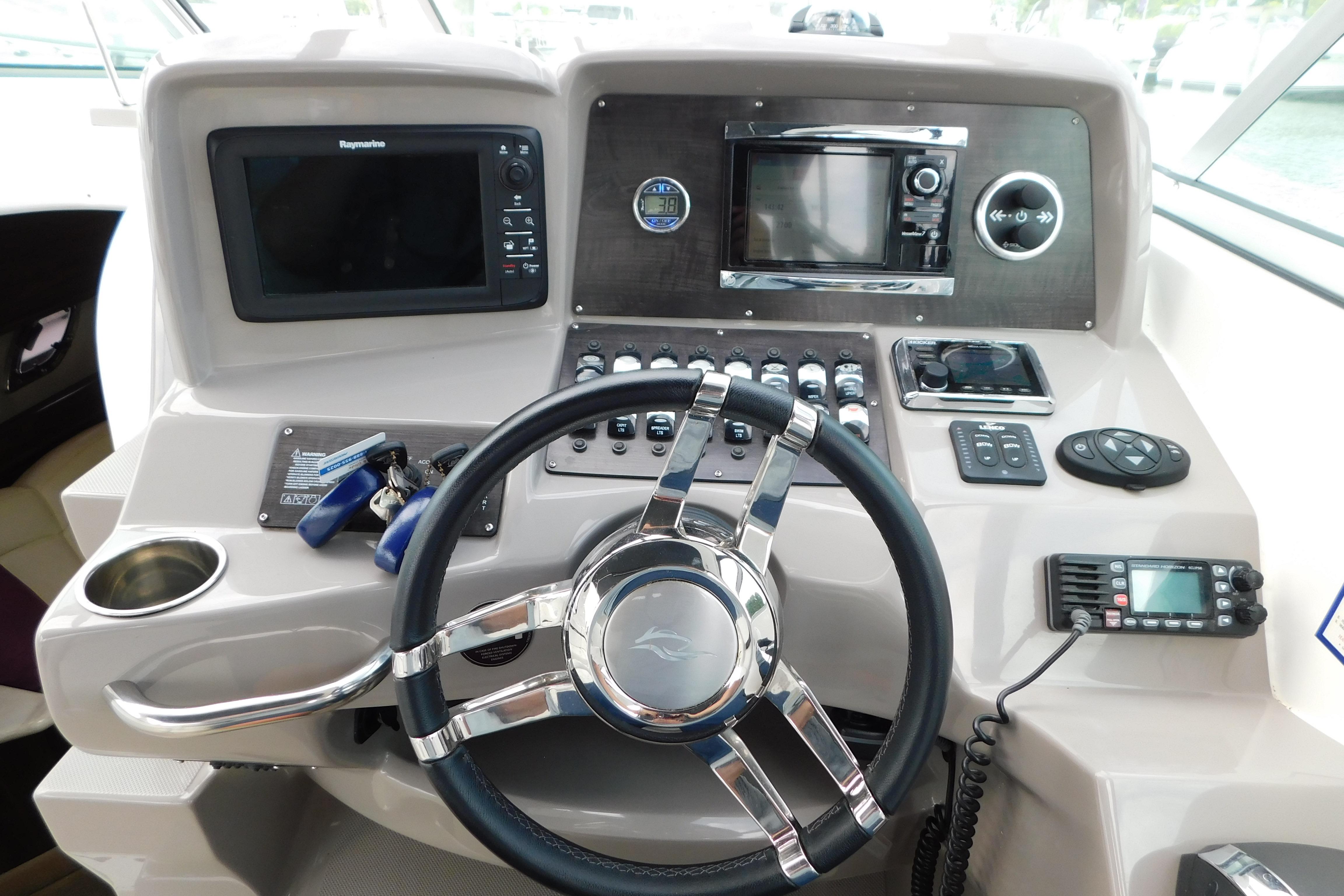 2017 Rinker EX 320 helm with steering wheel, navigation controls, and electronic displays.