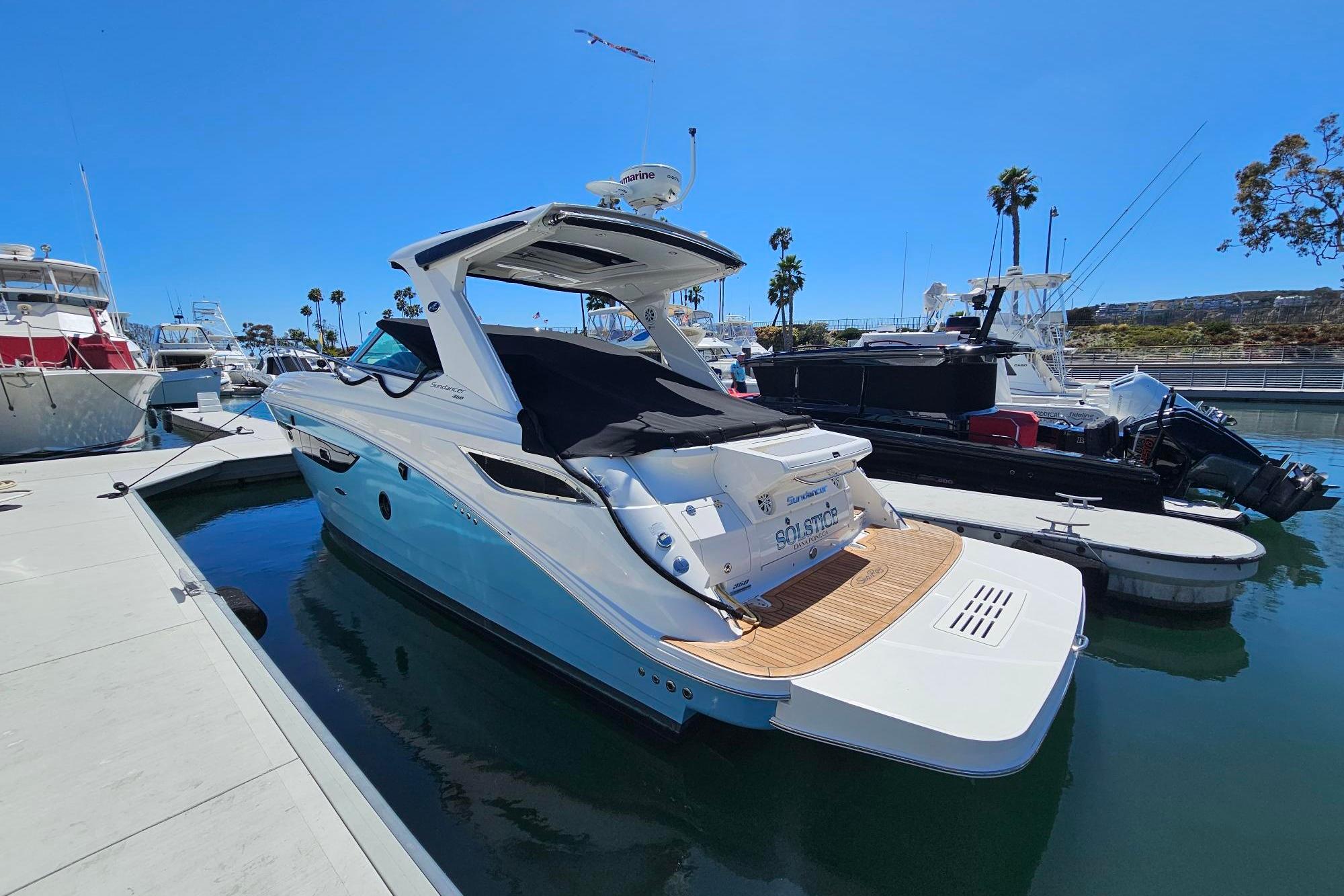 2016 Sea Ray Sundancer 350 yacht docked at marina under clear blue sky.