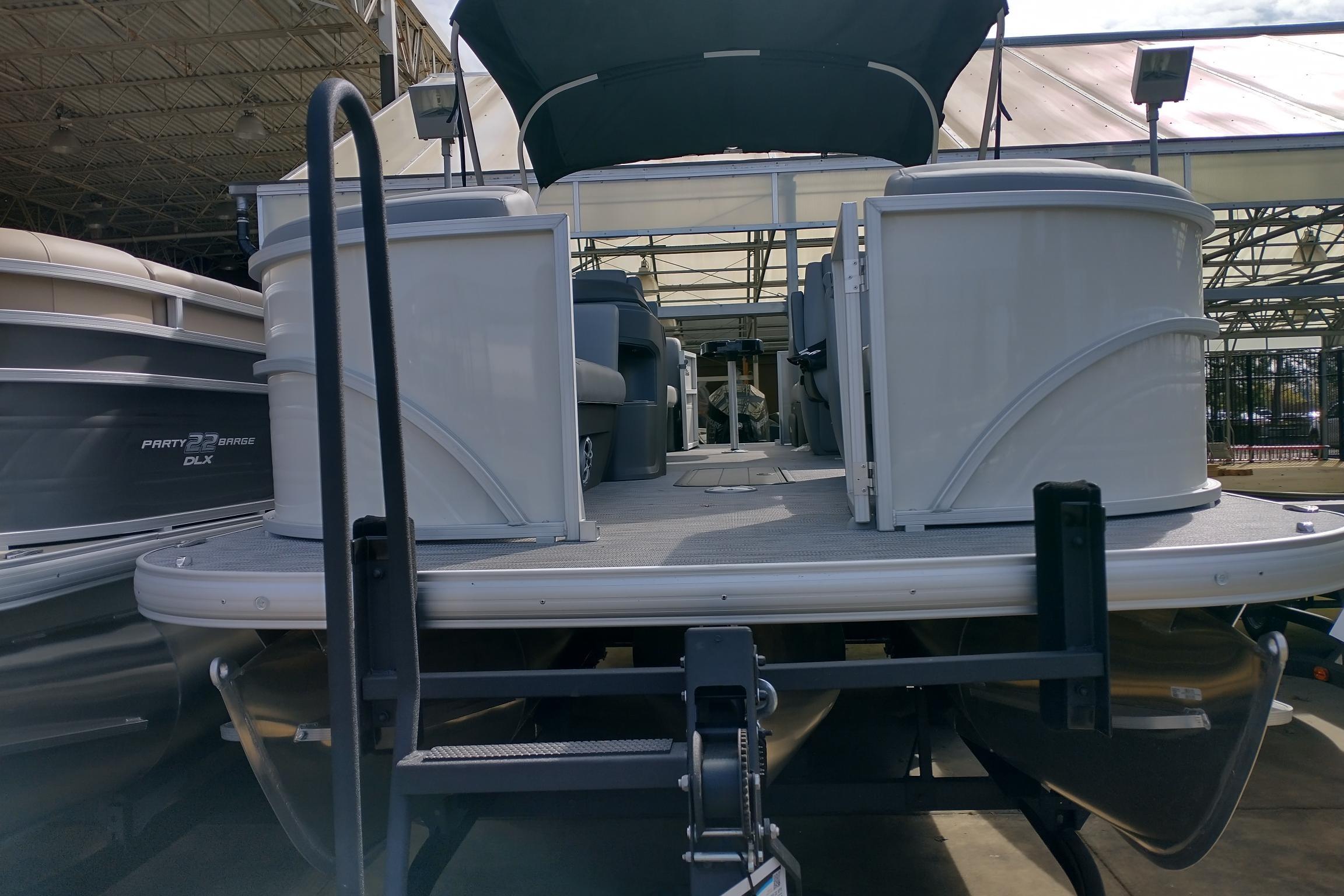 2026 Sun Tracker Party Barge 22 XP3 pontoon boat in a showroom setting.