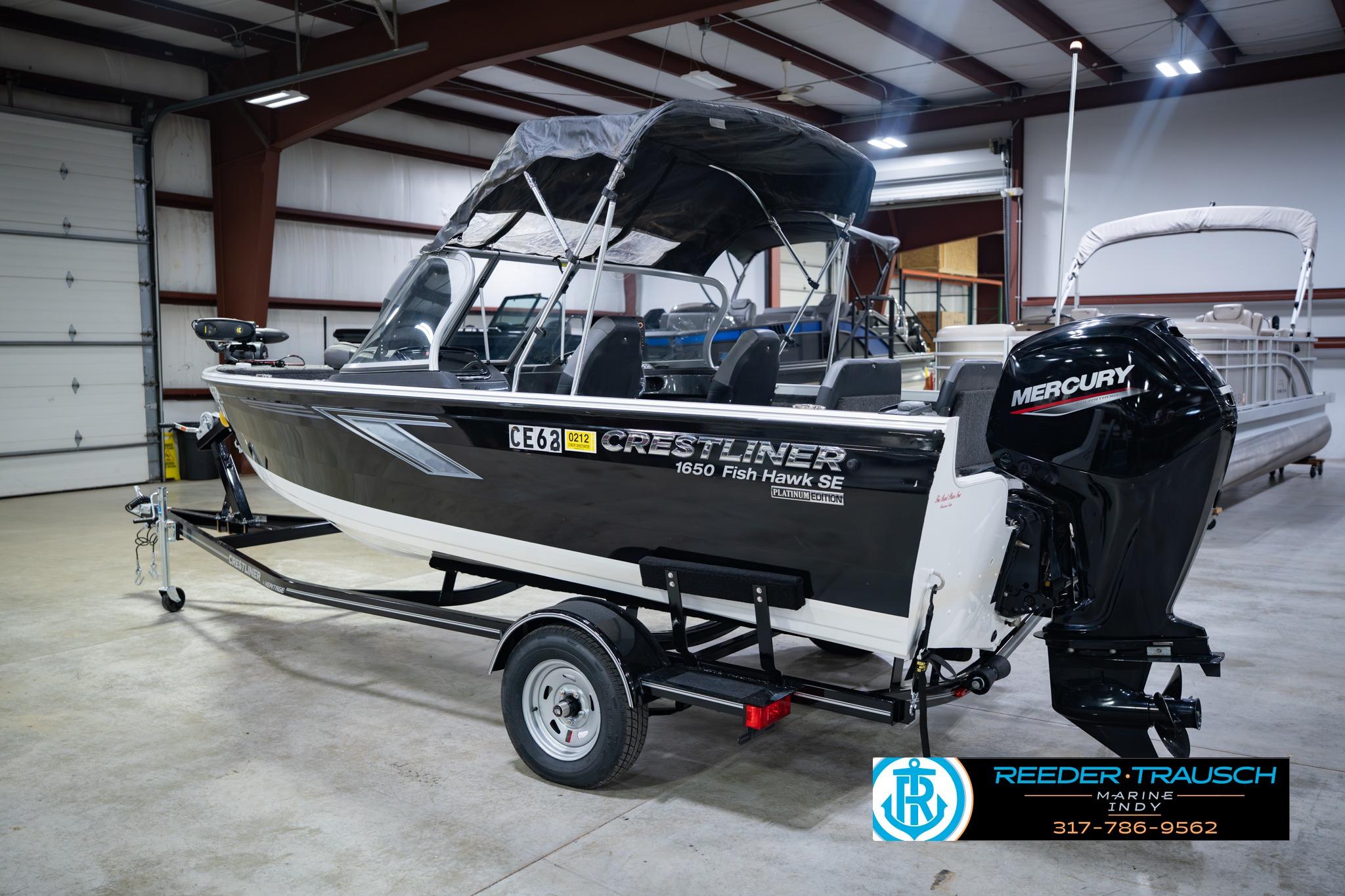 2014 Crestliner 1650 Fish Hawk SE boat with Mercury engine in indoor showroom.