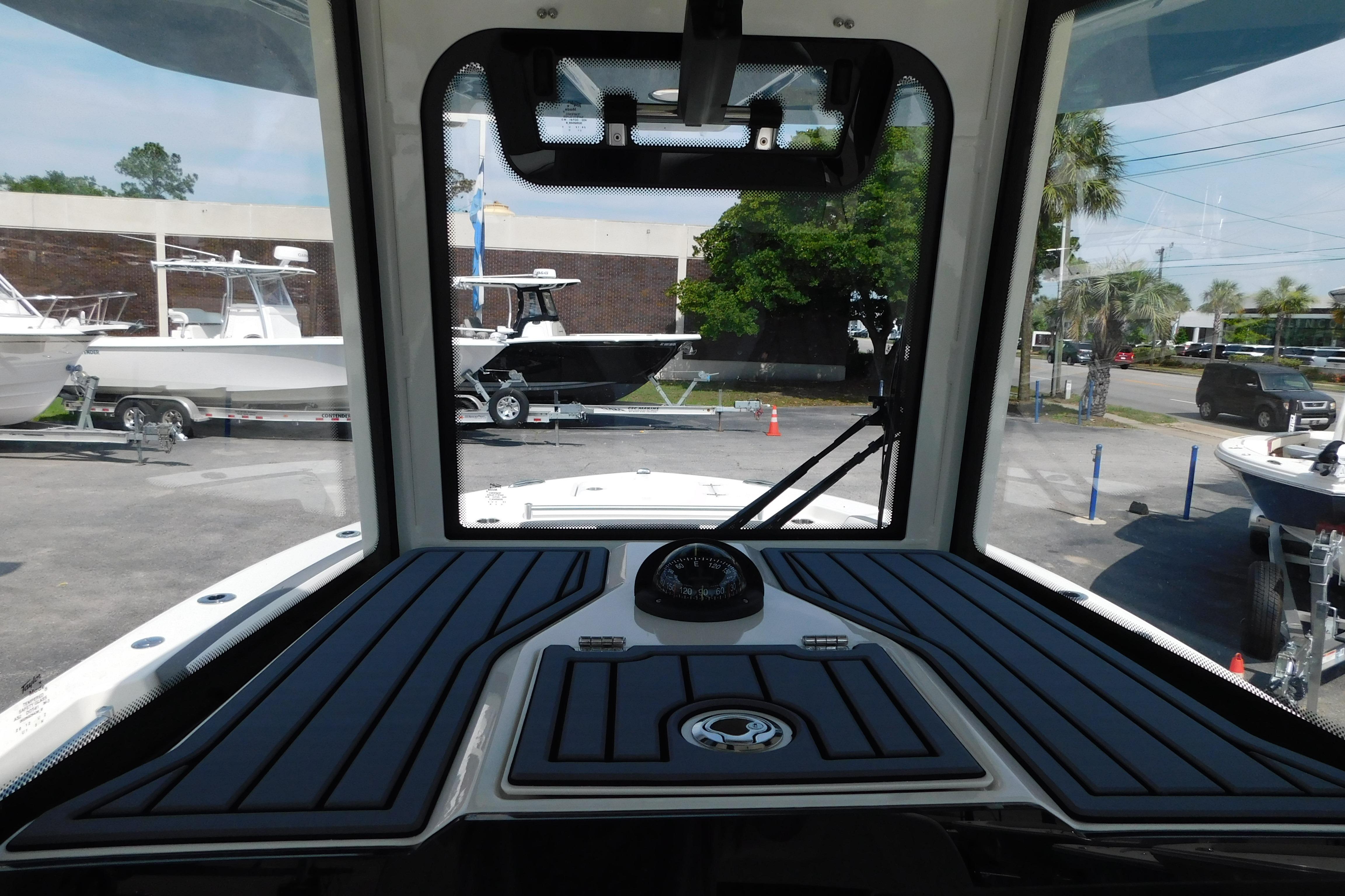 Interior view of 2026 Cobia 245 Center Console boat, showcasing dashboard and windshield.