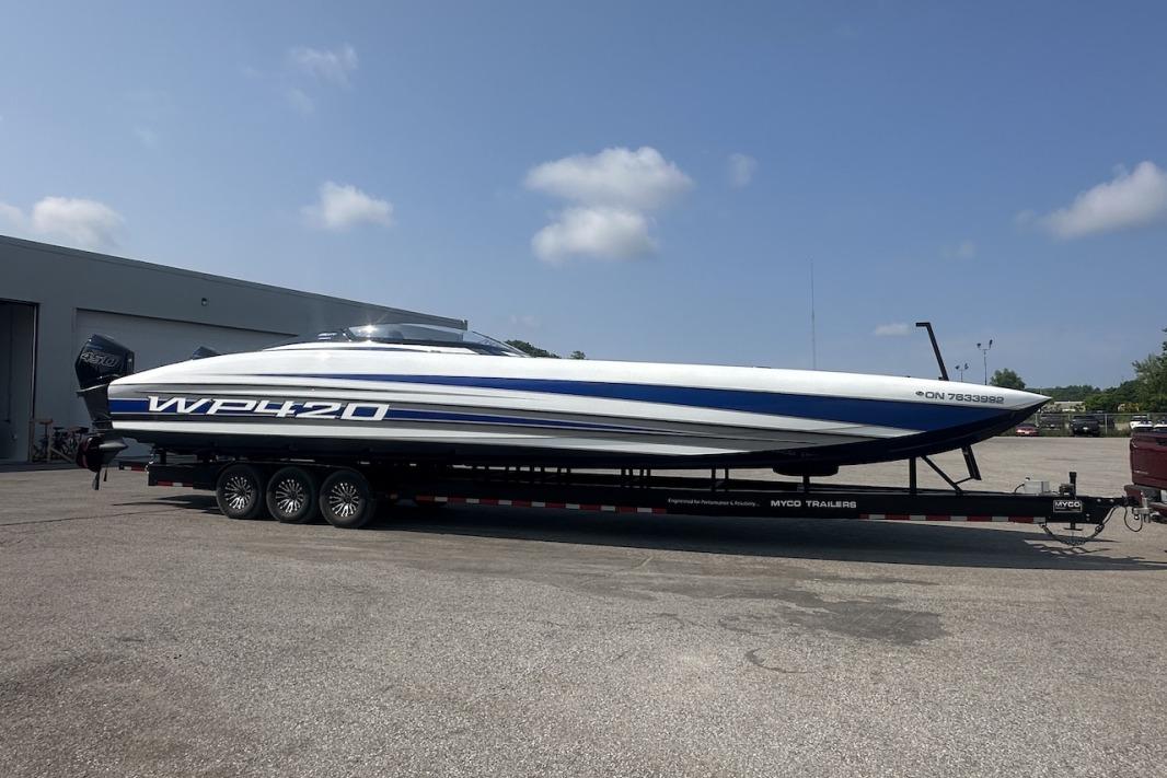 2018 Wright Performance 420 boat on trailer, parked outdoors under clear sky.
