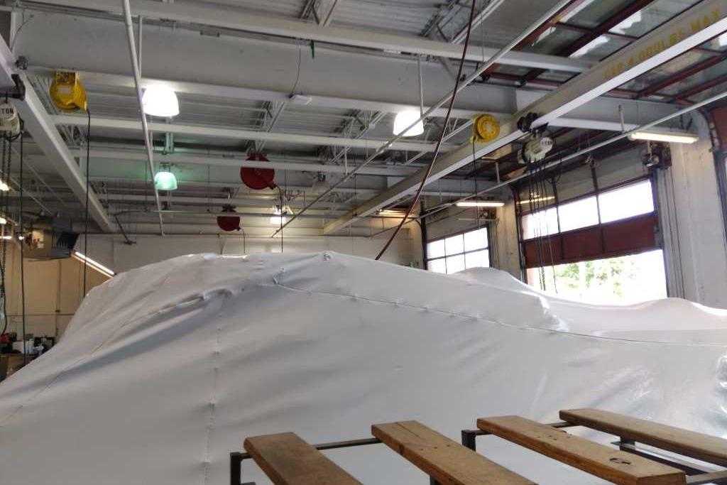 Covered 2025 Sun Tracker Party Barge 22 DLX in a spacious indoor storage facility.