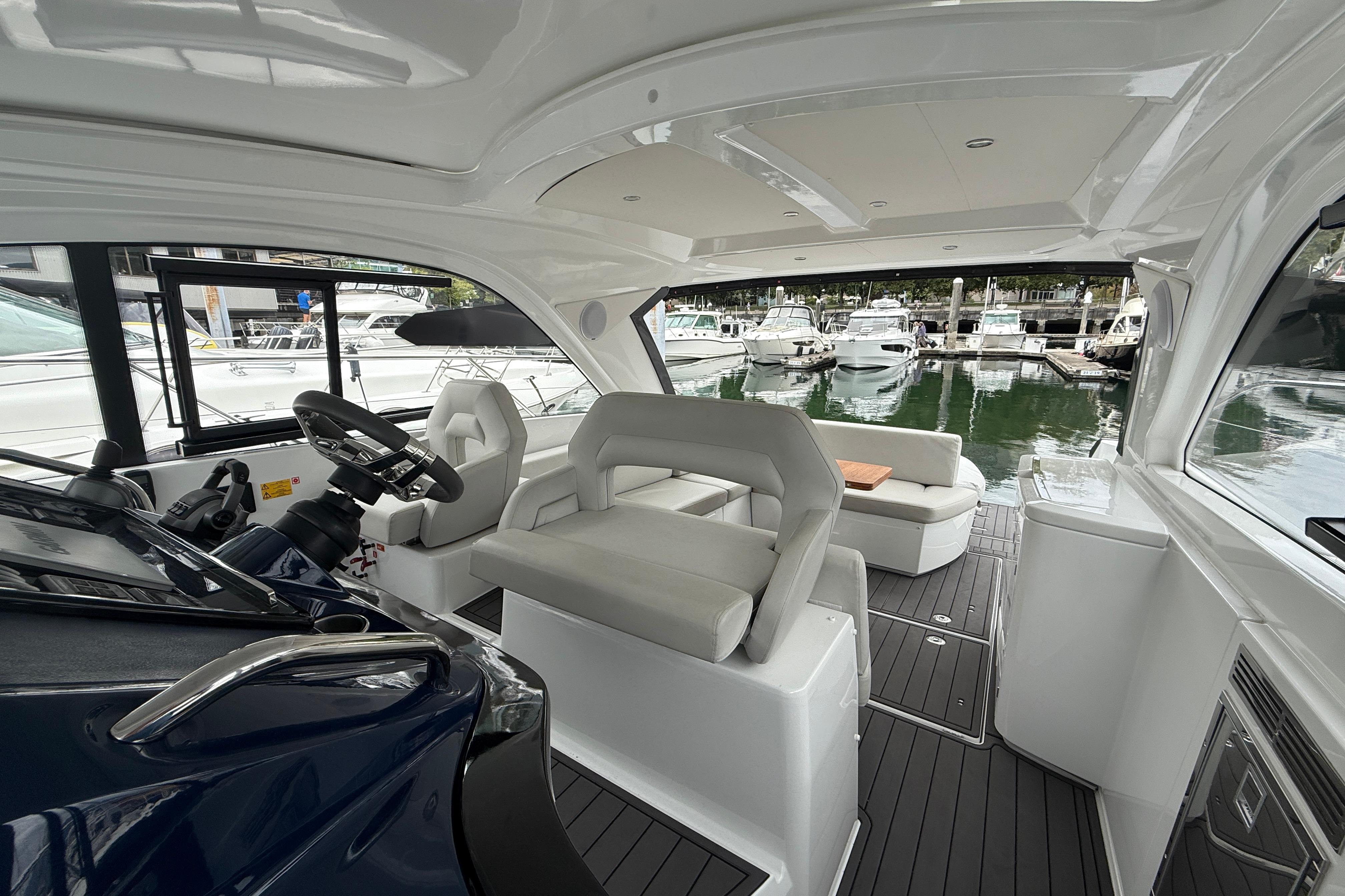 Interior of 2022 Beneteau Gran Turismo 41 yacht, featuring modern helm and seating area.