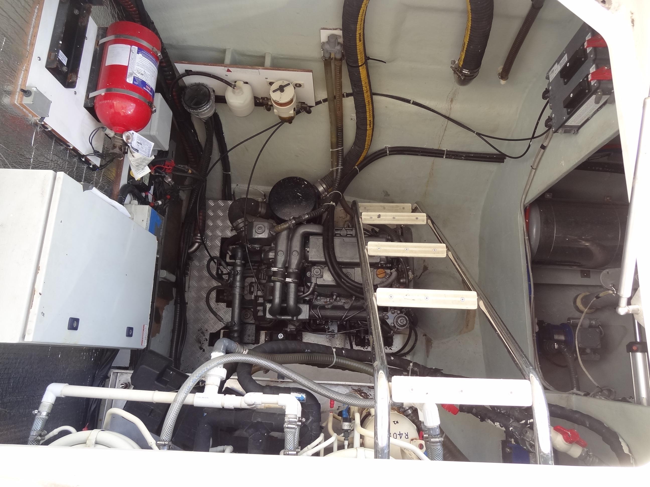 Engine room of a 2014 Leopard 58 yacht with visible machinery and fire extinguisher.
