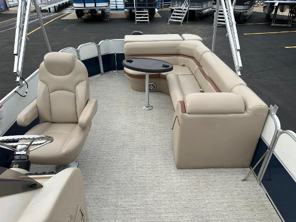 The image shows the interior of a 2018 South Bay S224CR pontoon boat with beige seating.