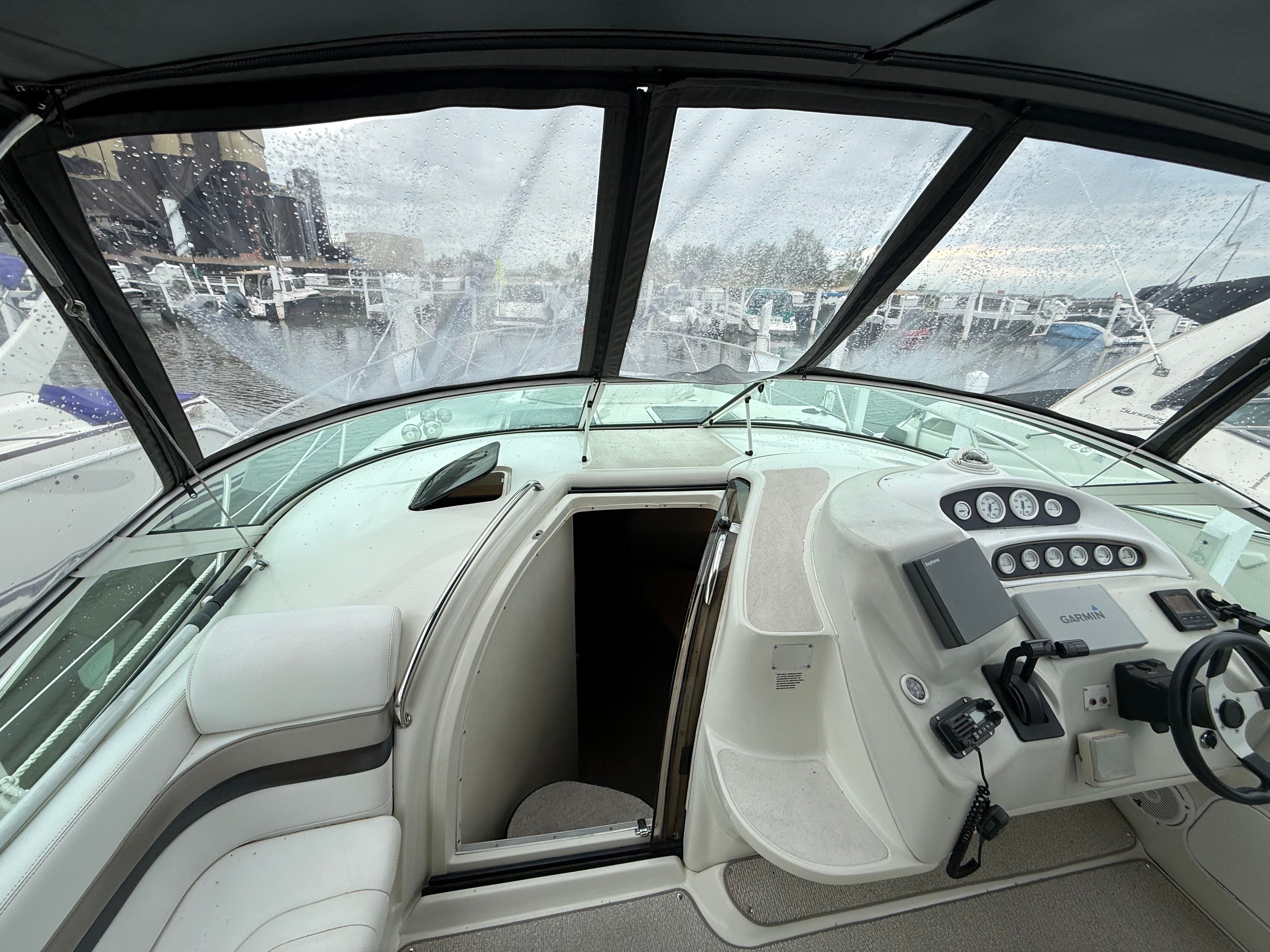 The cockpit of a 1995 Silverton 360 with helm and seating area.