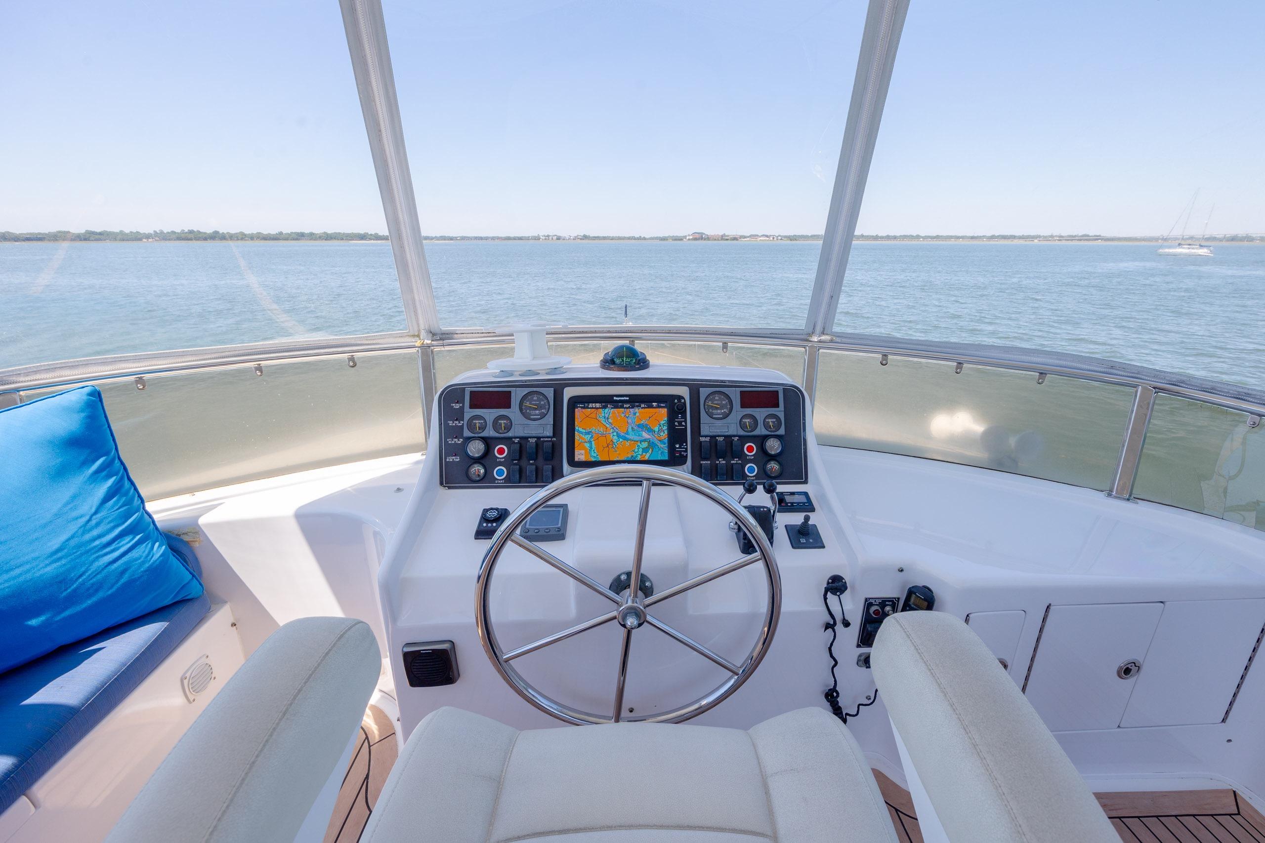 Helm of 2005 Ocean Alexander 52 Sedan yacht with navigation controls and ocean view.