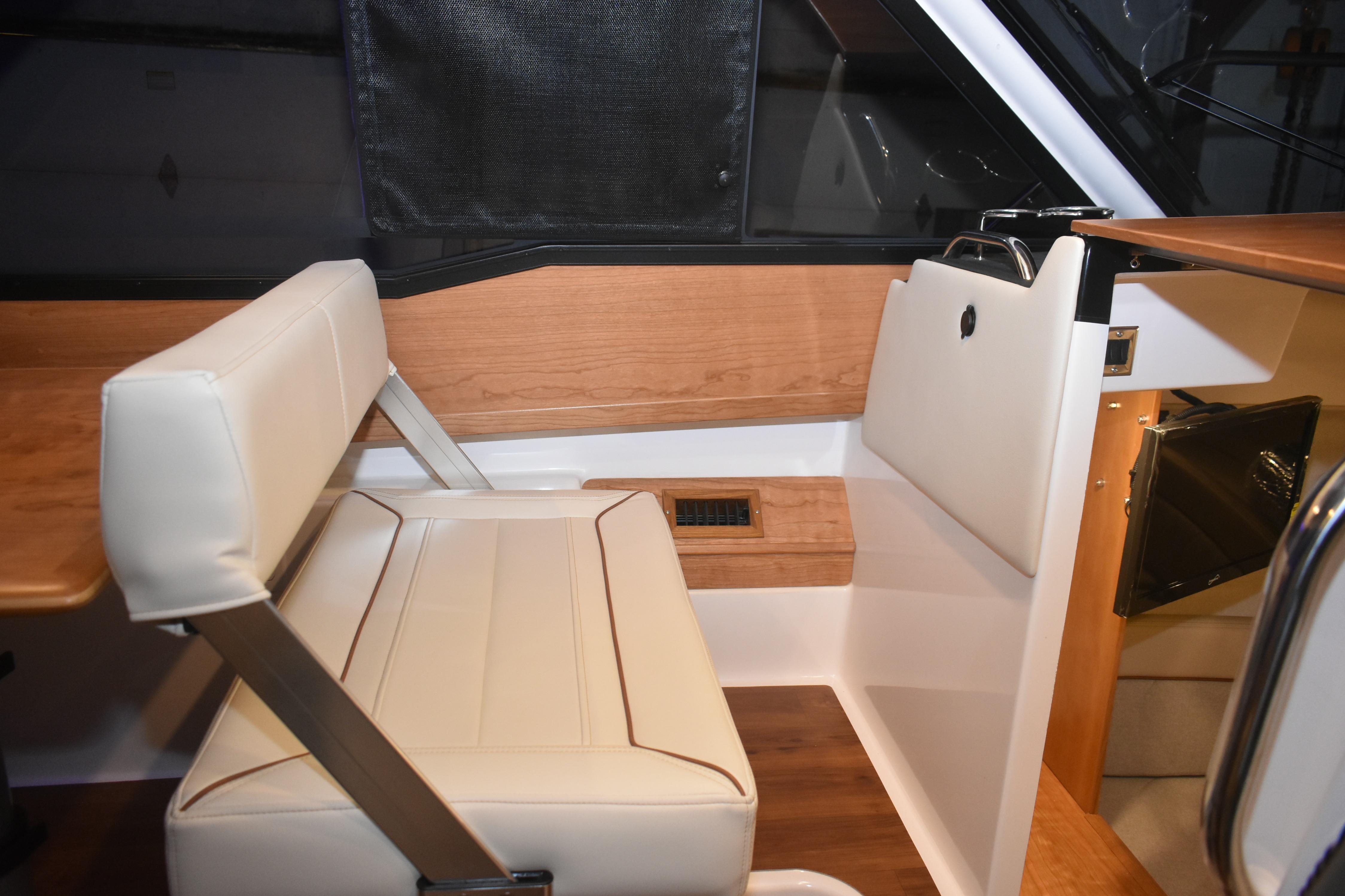 Interior of 2026 Cutwater C-248 Coupe featuring elegant seating and wood accents.
