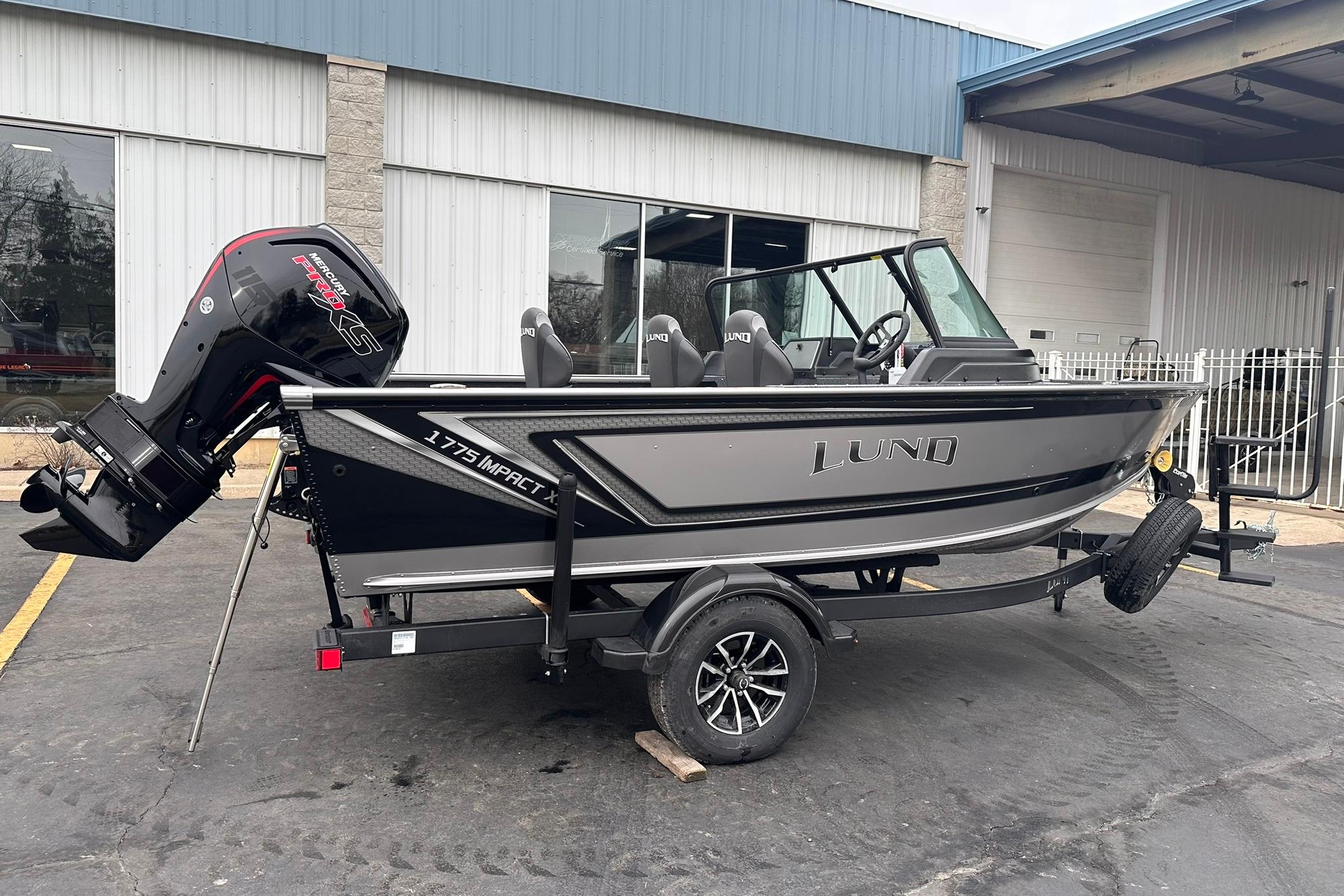 2026 Lund 1775 Impact XS Sport boat with Mercury engine on trailer.