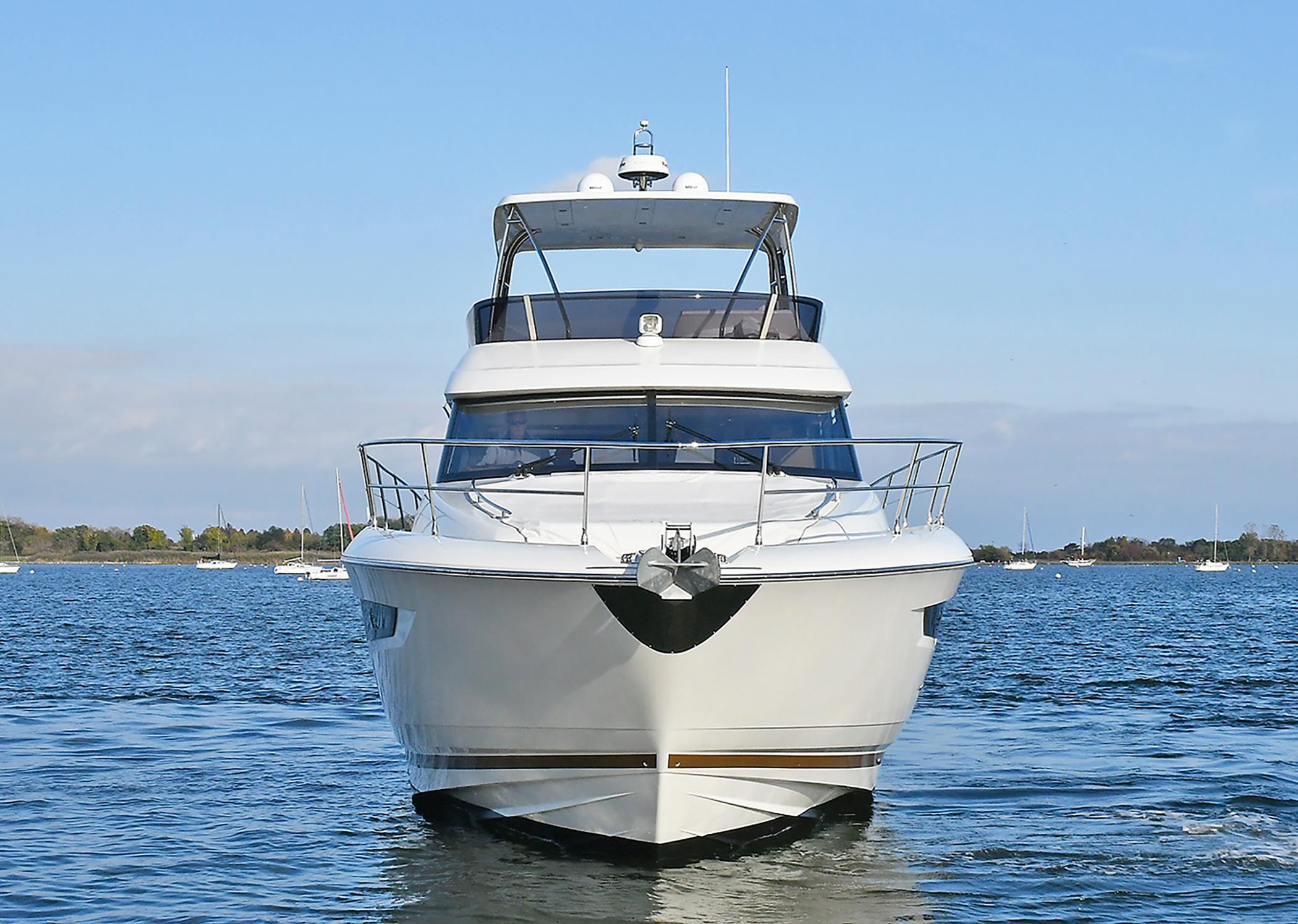 2018 Prestige 560 Fly yacht on calm water, front view.
