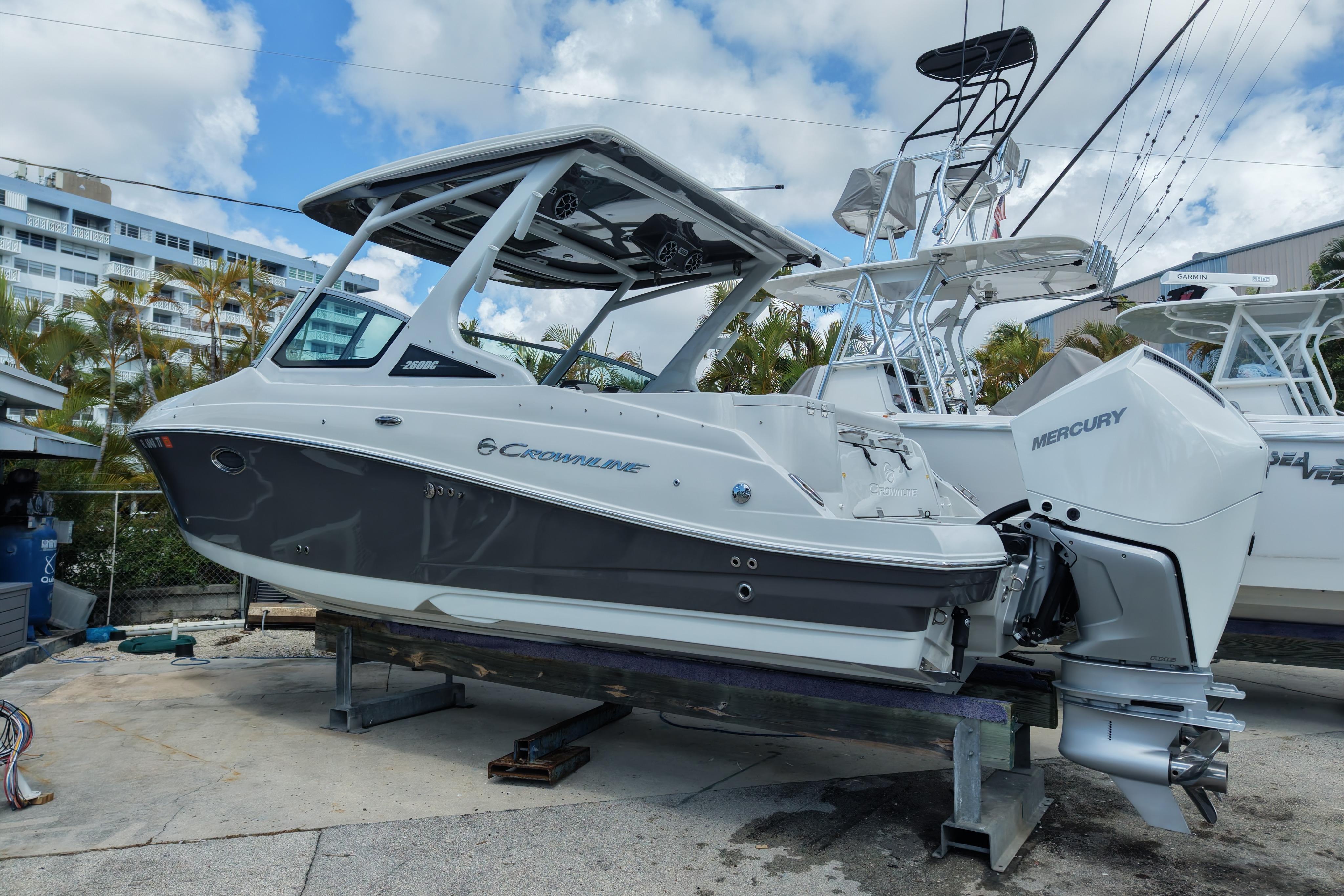 2024 Crownline 260 DC Finseeker boat with Mercury engine on display.