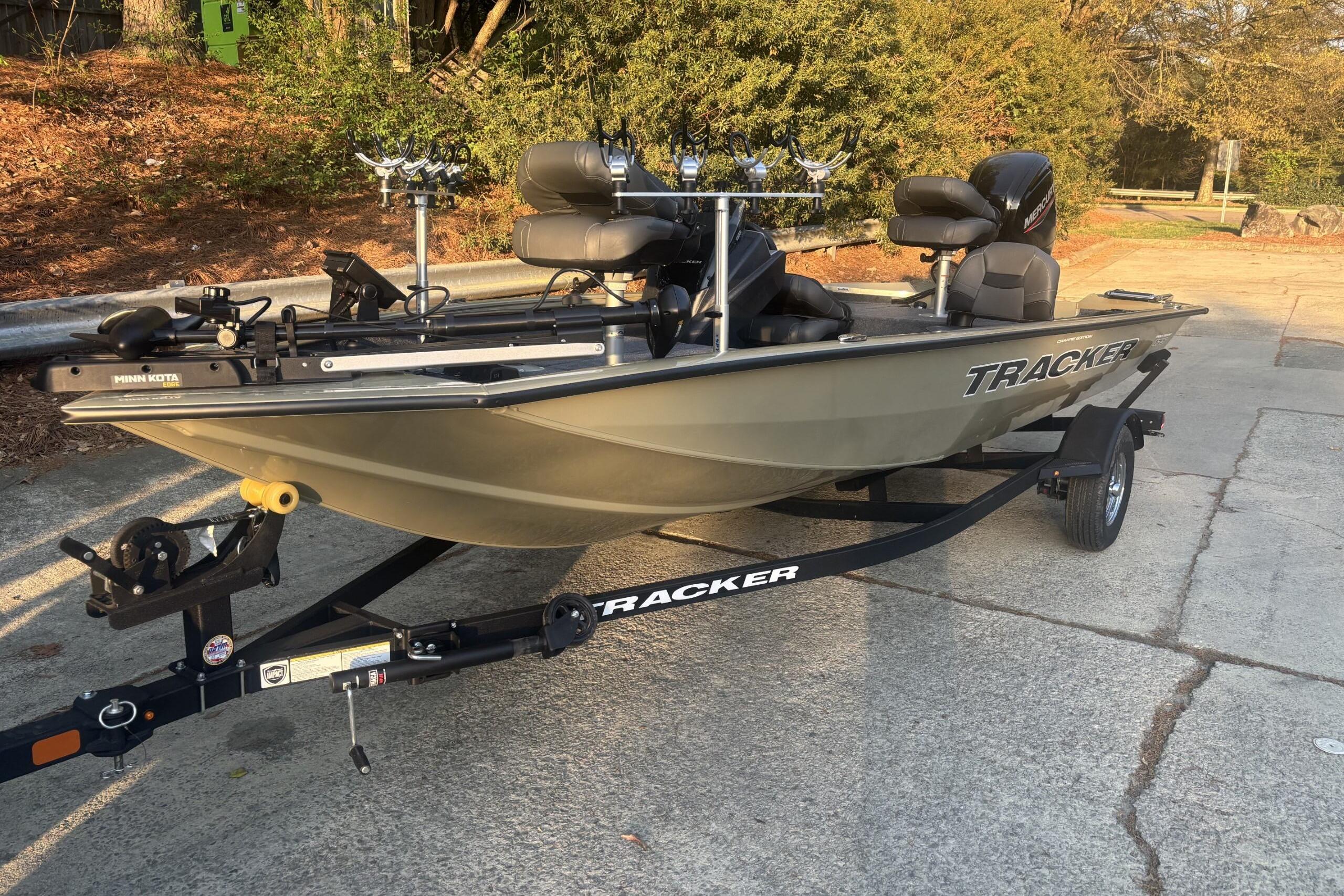 2026 Tracker Pro Team 175 Crappie Edition boat on trailer, parked outdoors.