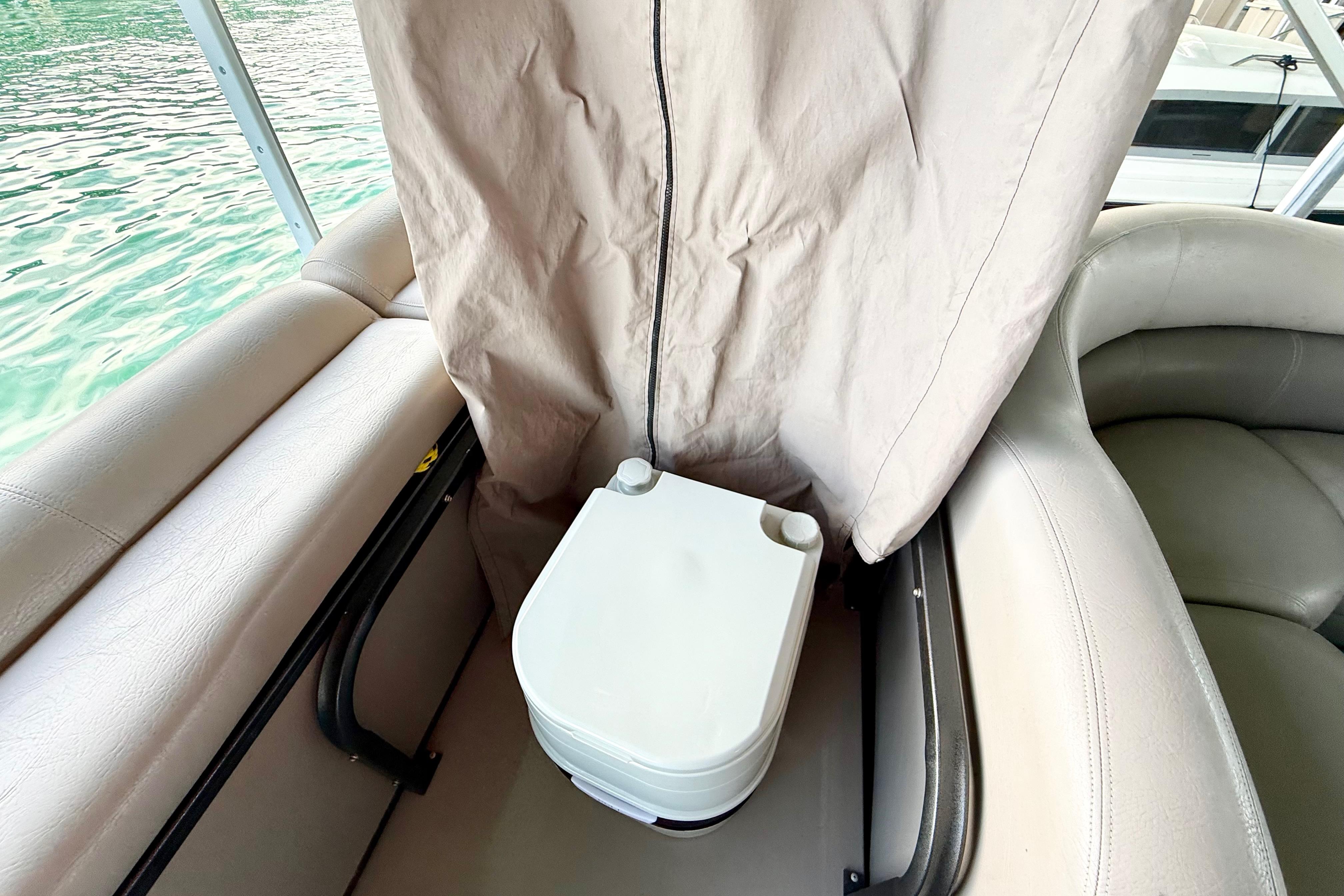 Interior of 2011 Premier 275 Grand Majestic PTX with portable toilet and privacy curtain.