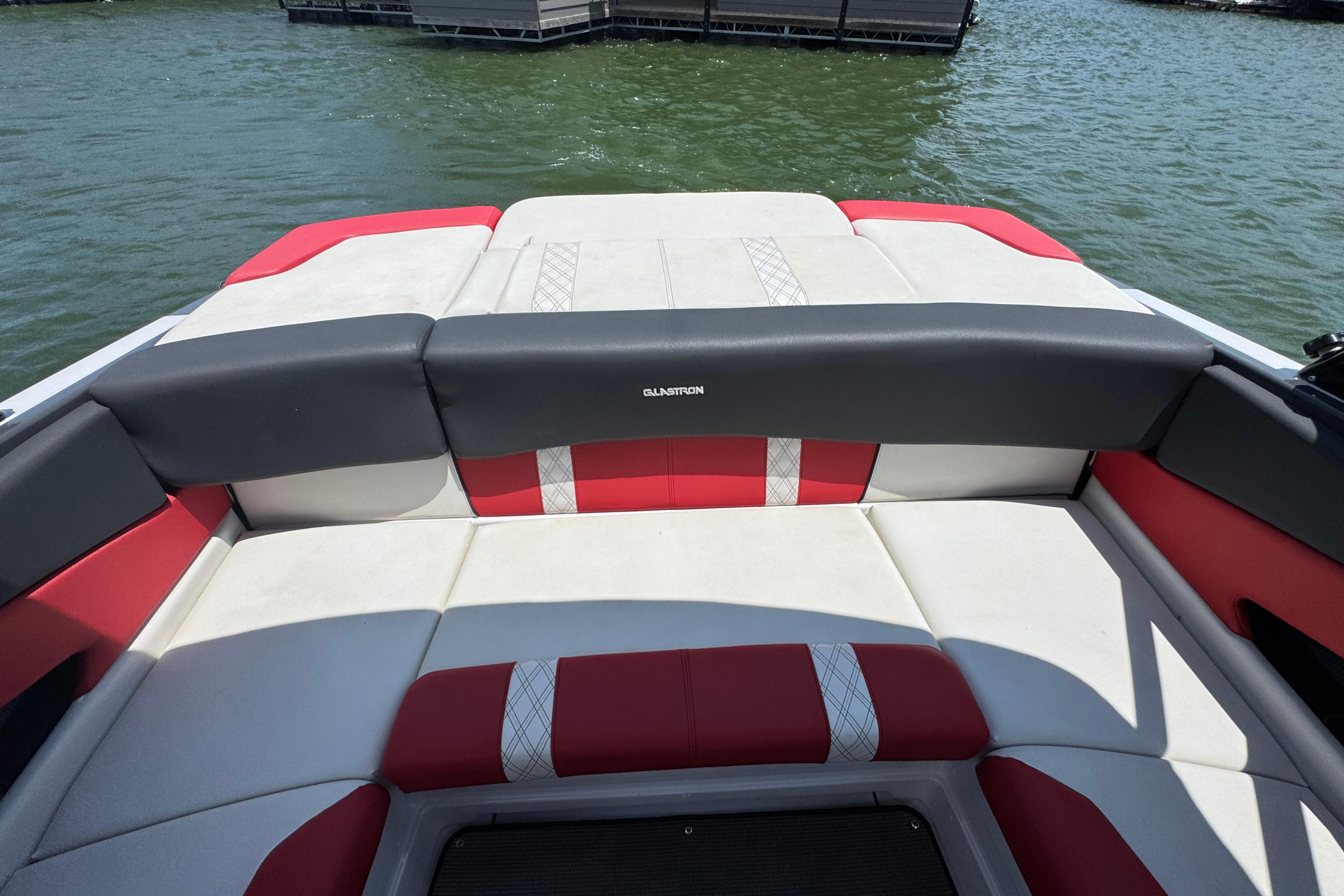 2017 Glastron GT 225 boat interior with red and white seating on the water.