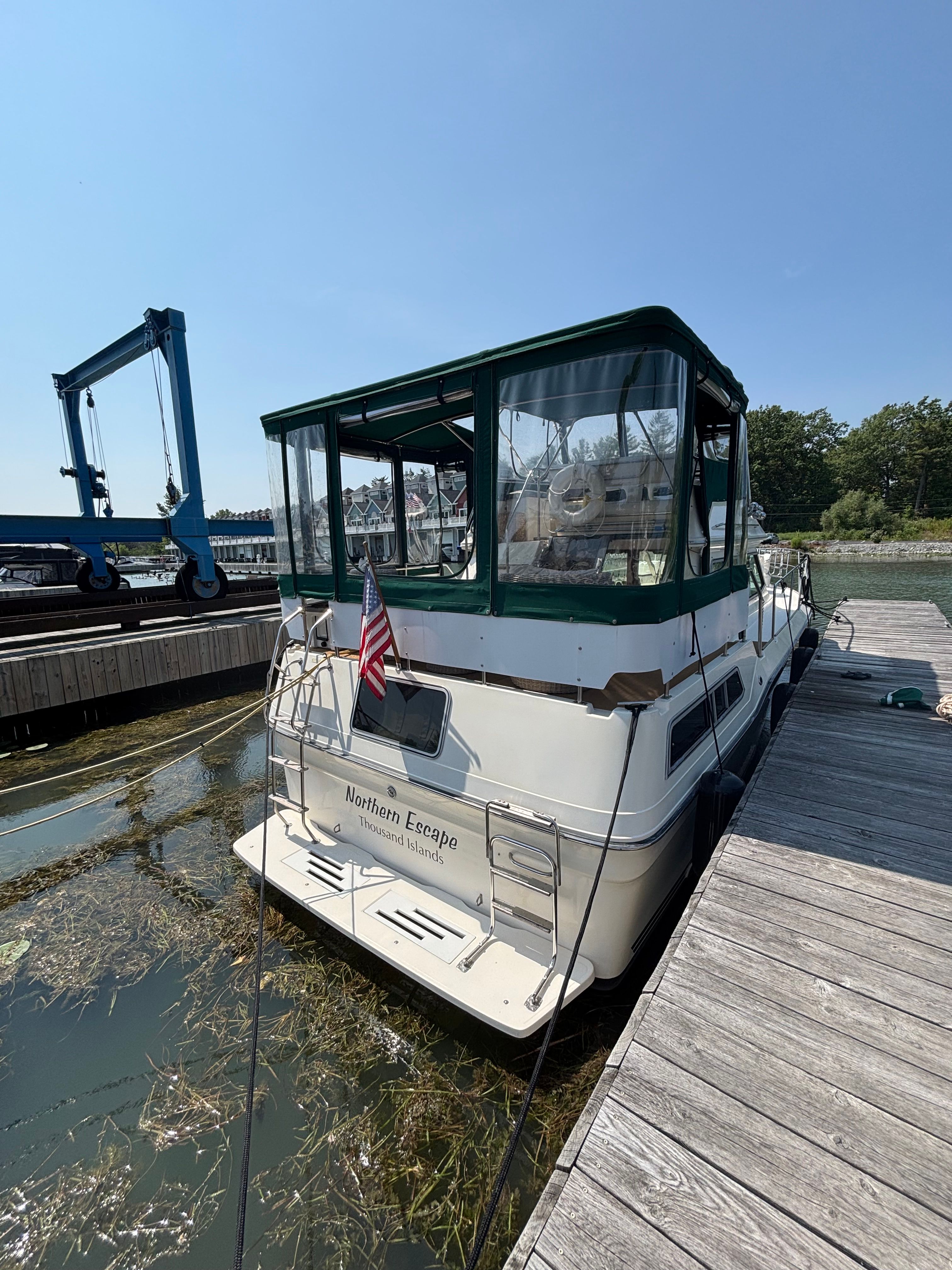 1986 Sea Ray 360 Aft Cabin docked with green canopy.