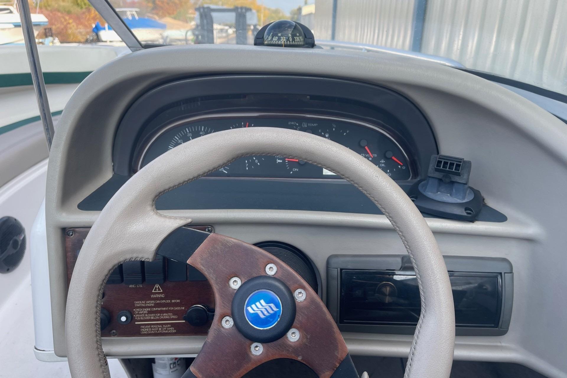 Steering wheel and dashboard of 1996 Four Winns 200 Horizon boat.