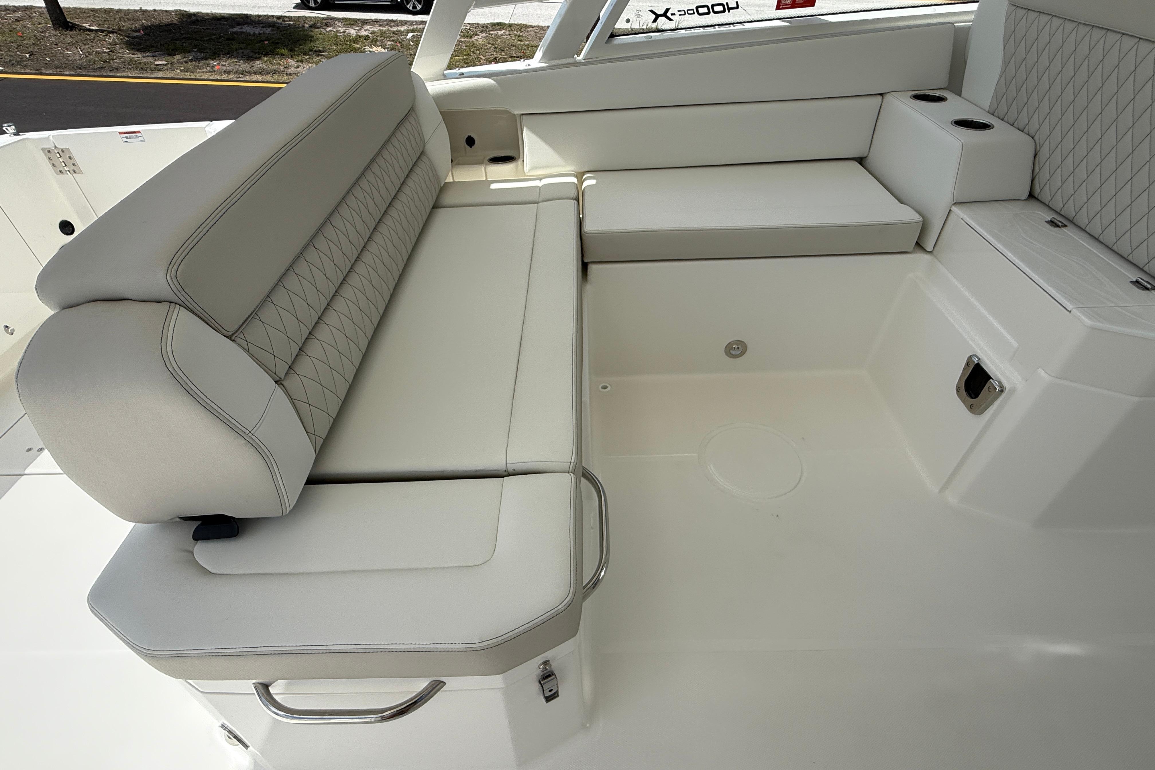 Luxurious seating on 2026 World Cat 400 DC-X Island boat, featuring elegant upholstery.