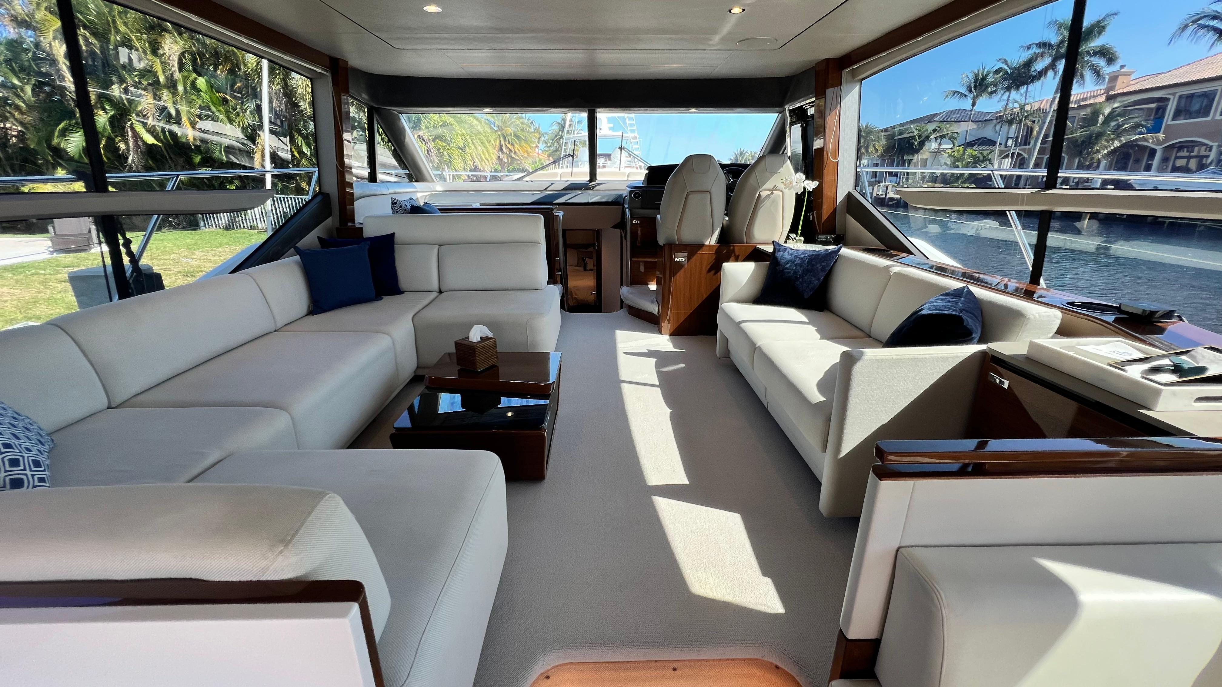 Luxurious interior of a 2019 Princess F62 yacht with elegant seating and panoramic windows.