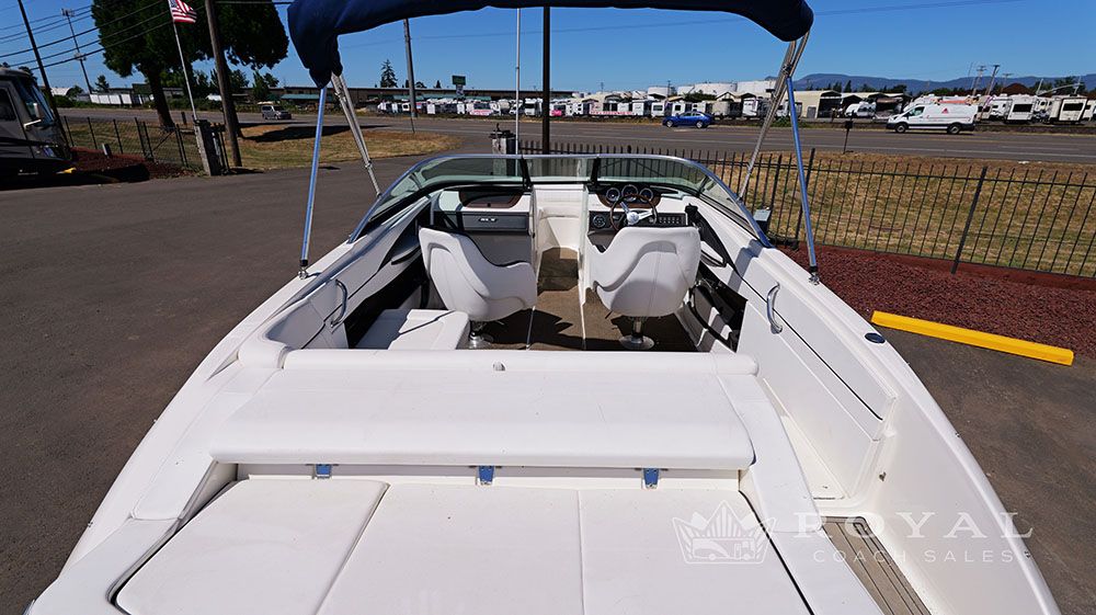 2014 Sea Ray SLX 230 with open cockpit and blue sunshade.