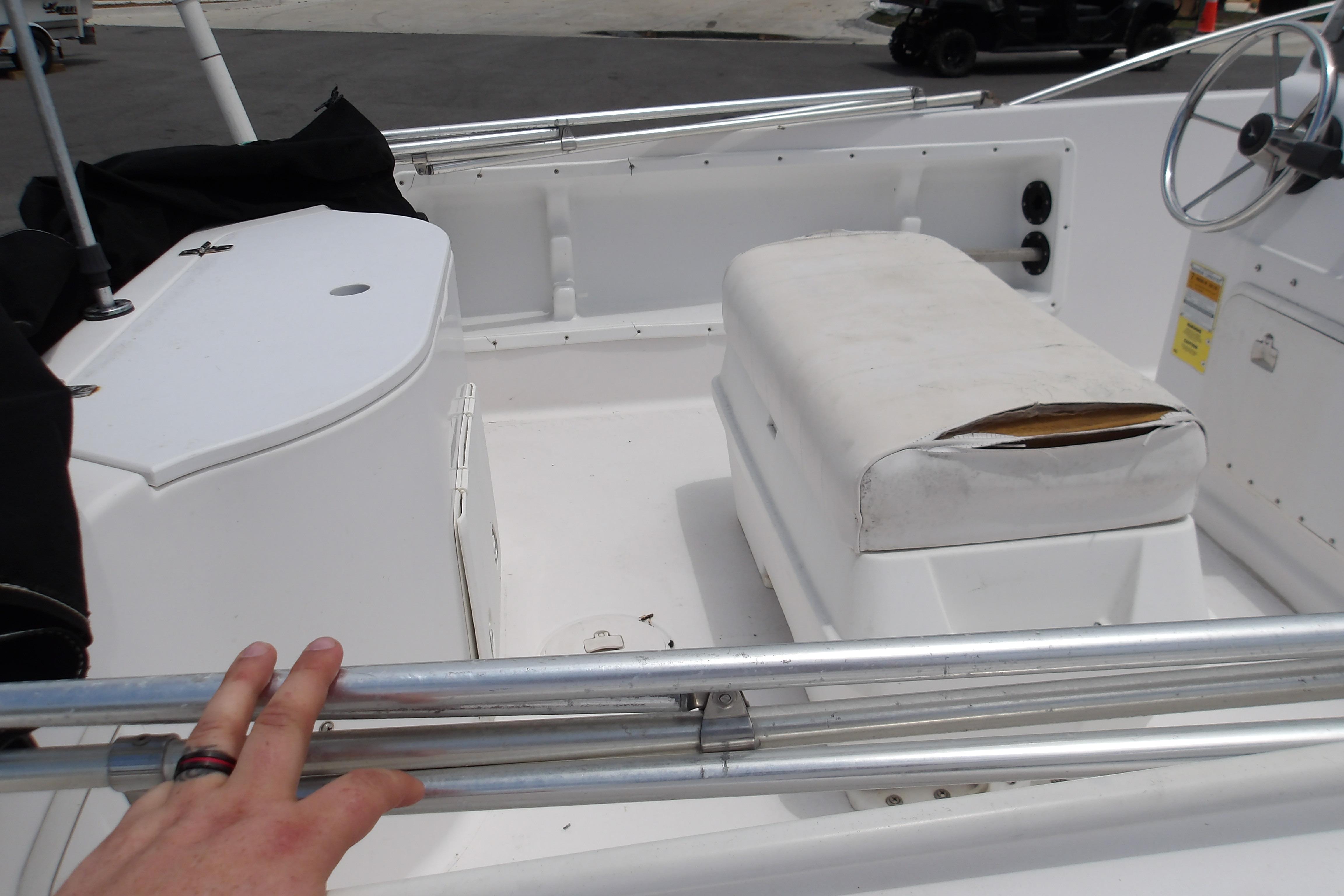 2000 Pro-Line 19 Sport boat interior with worn seating and steering wheel.