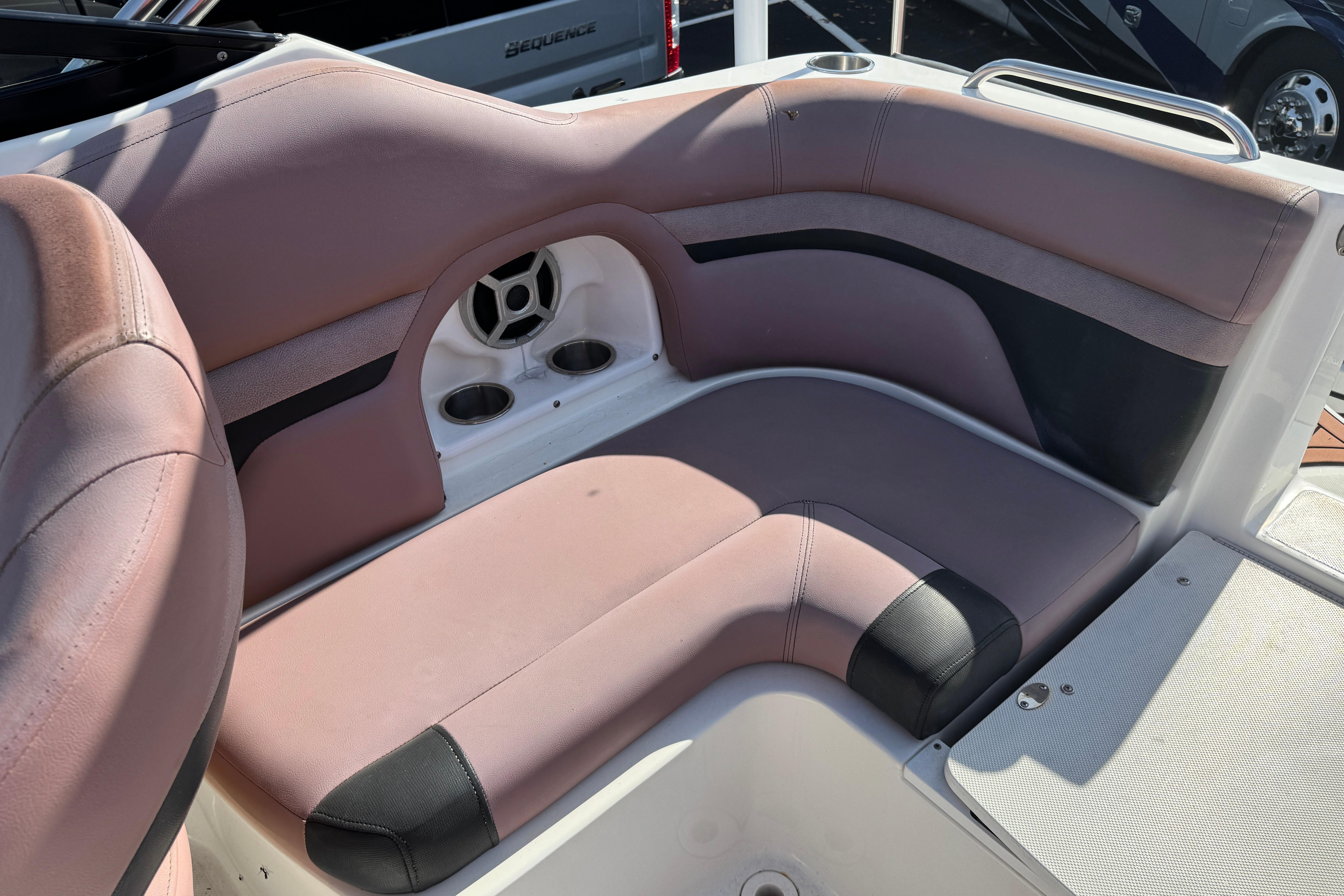 2018 Hurricane SunDeck 2400 OB boat interior seating with cup holders and speaker.