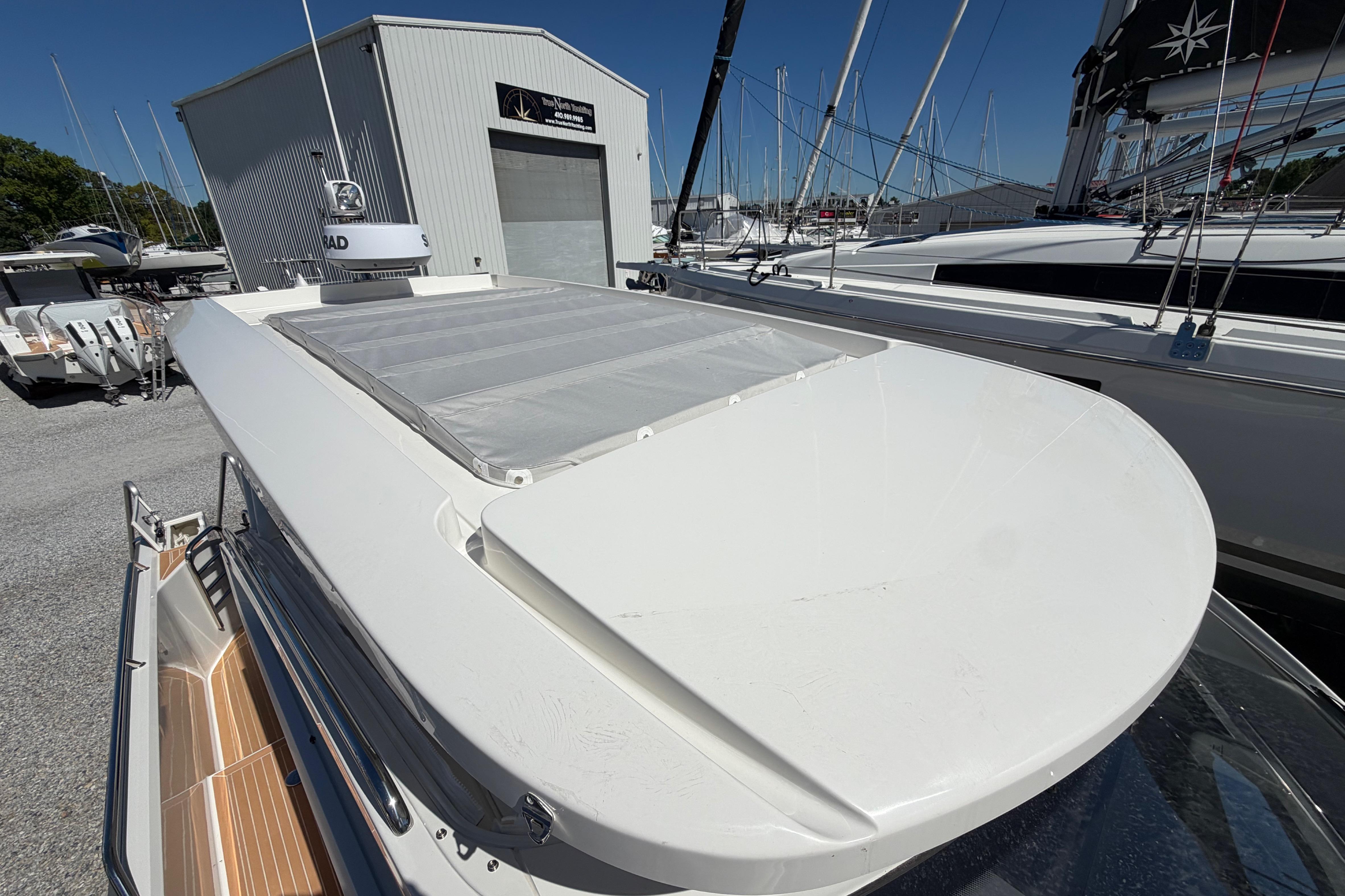 2025 Nimbus Weekender 9 boat docked, showcasing sleek design and radar equipment.