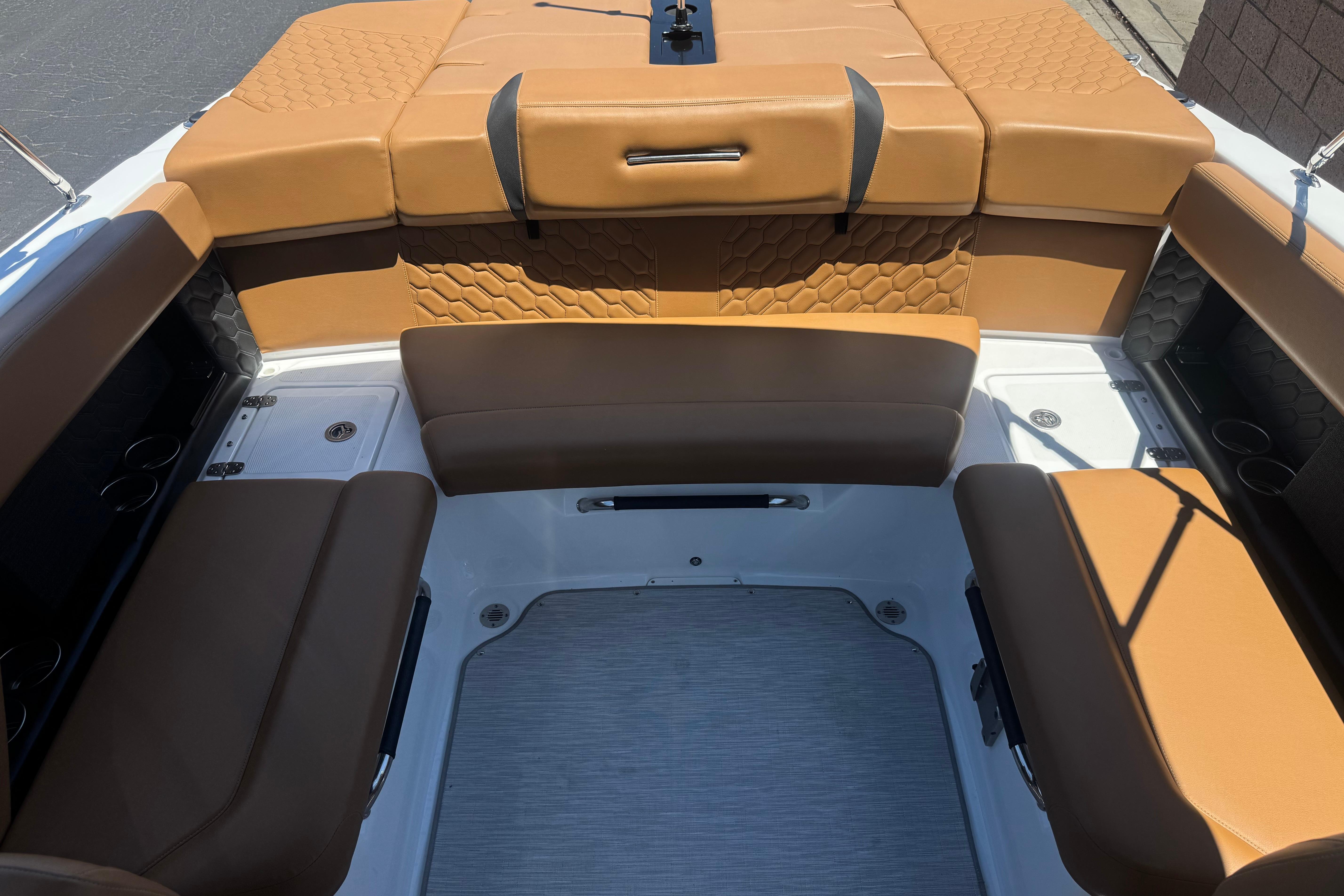 Luxurious seating area of 2022 Four Winns H4 boat with tan upholstery.
